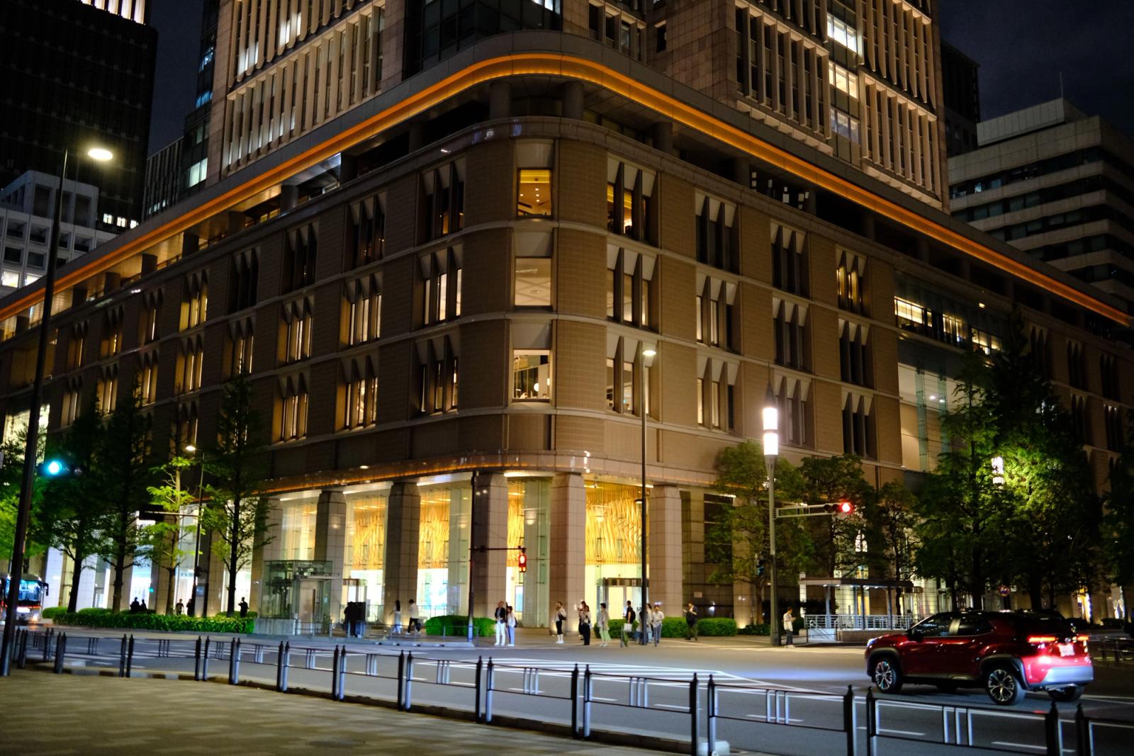 Contemporary architecture of Marunouchi at night in Tokyo, Japan, with urban activity