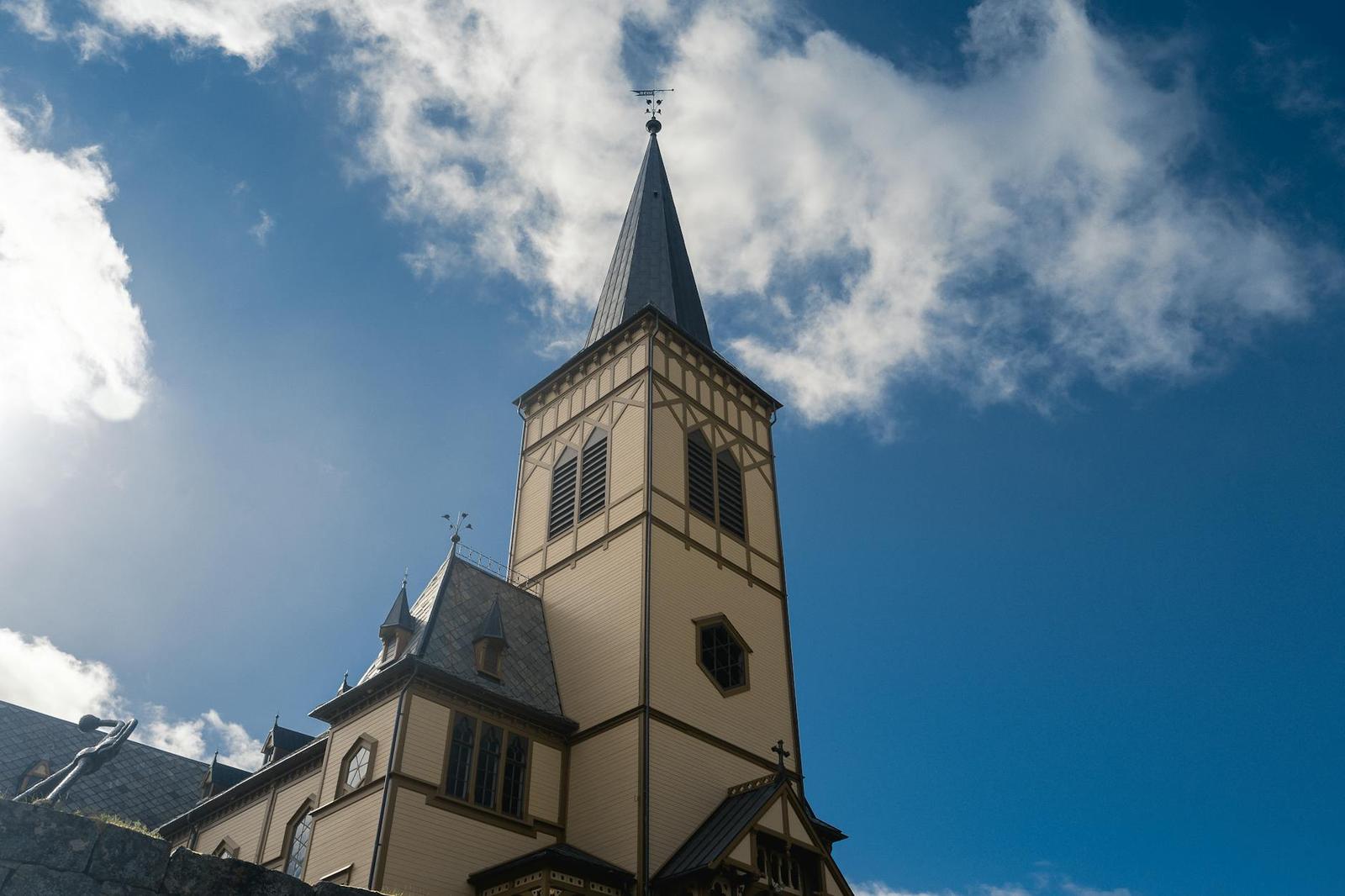 Elegant Vågan Church steeple under a bright sky in Svolvær, Nordland, Norway