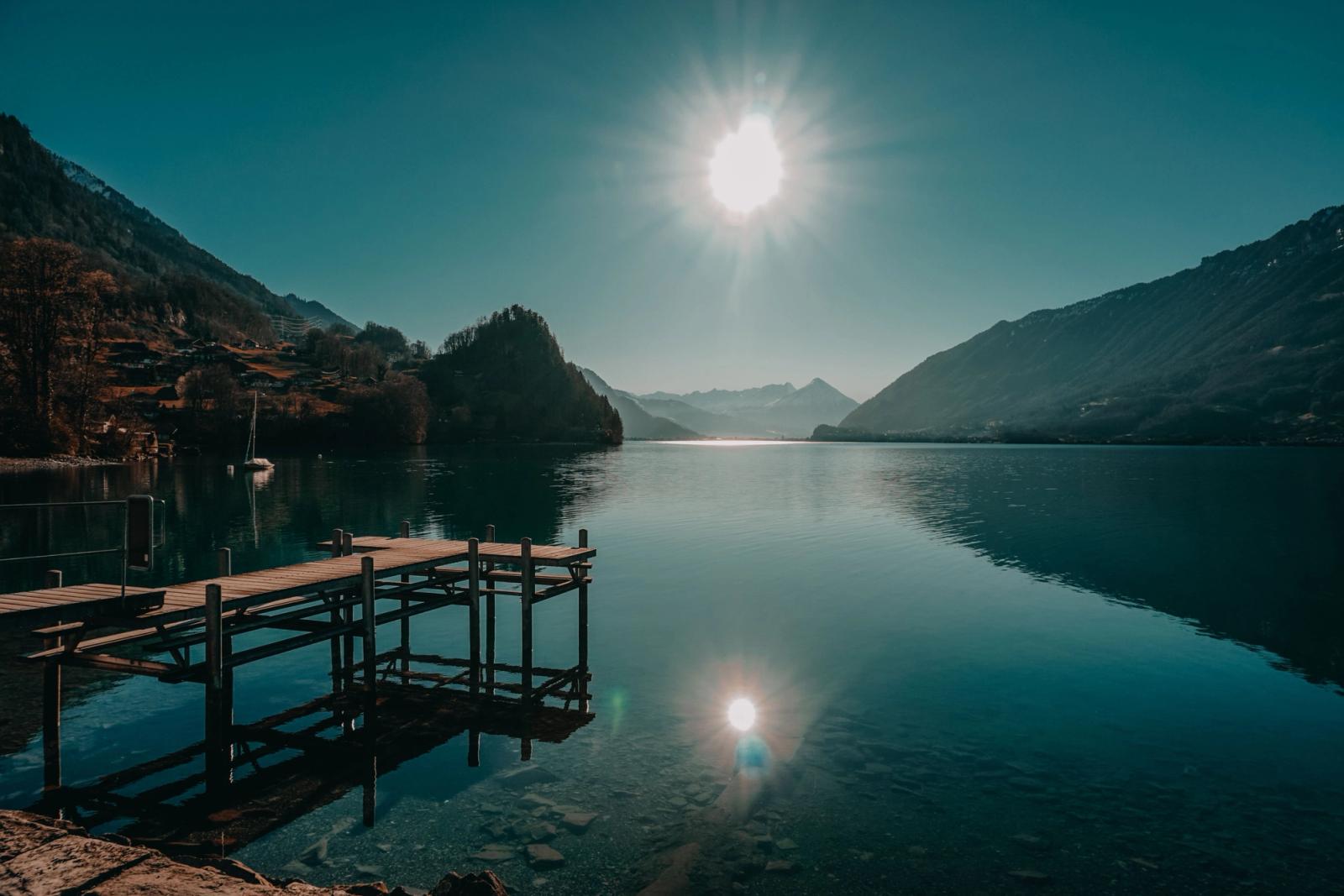 Scenic view of a tranquil lake and mountains at Interlaken, captured under bright daylight reflecting the serene natural beauty