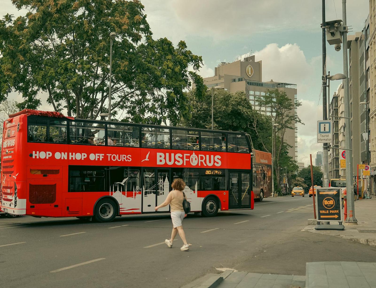 Tourists enjoy a double decker tour bus ride in a bustling city area