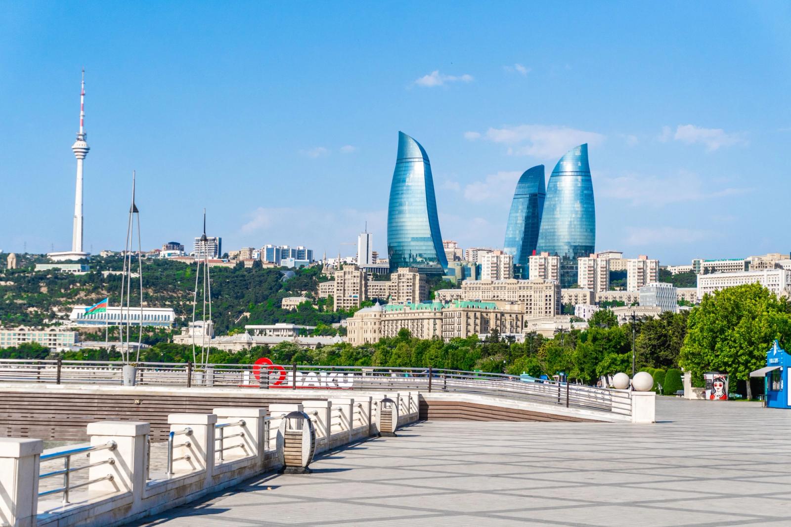 Panoramic view of Baku's Flame Towers and cityscape under a clear blue sky