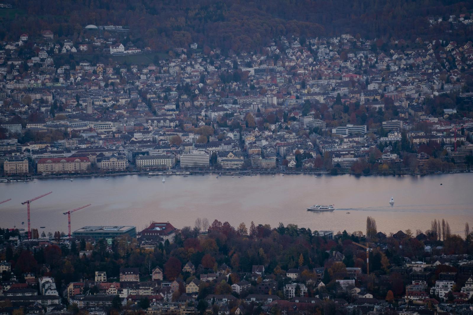 A scenic aerial view of Lake Zurich with the waterfront and surrounding cityscape during fall