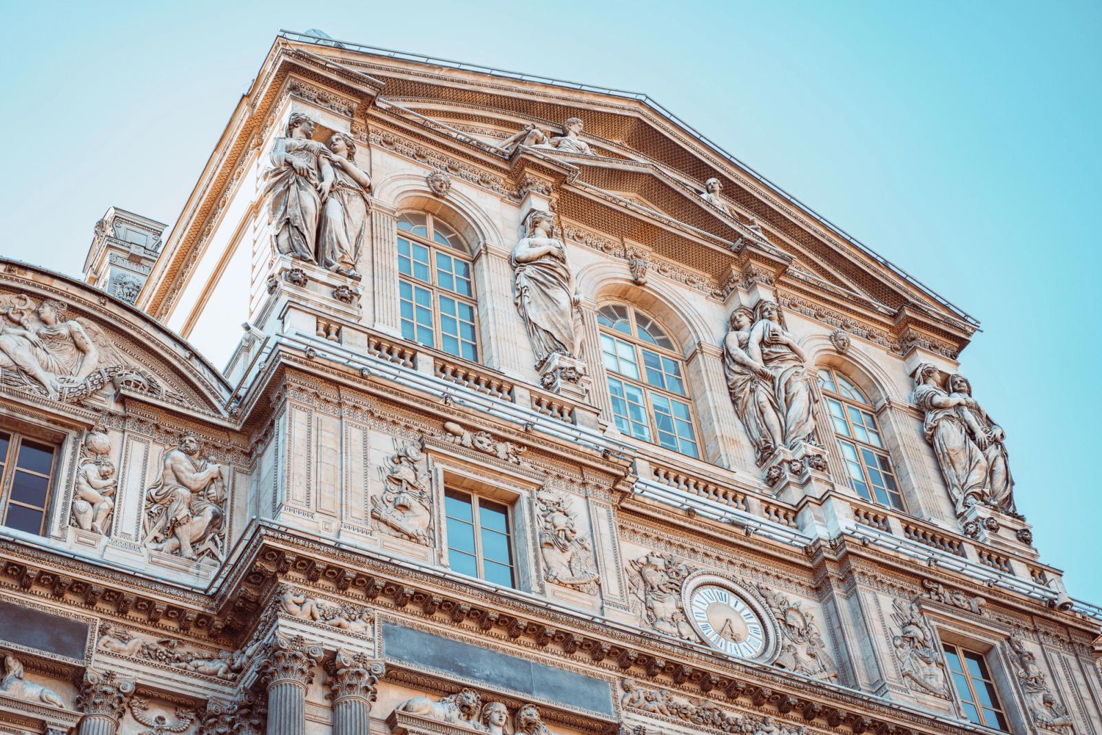 Detailed view of the historic Louvre Museum facade in Paris capturing intricate sculptures and architecture