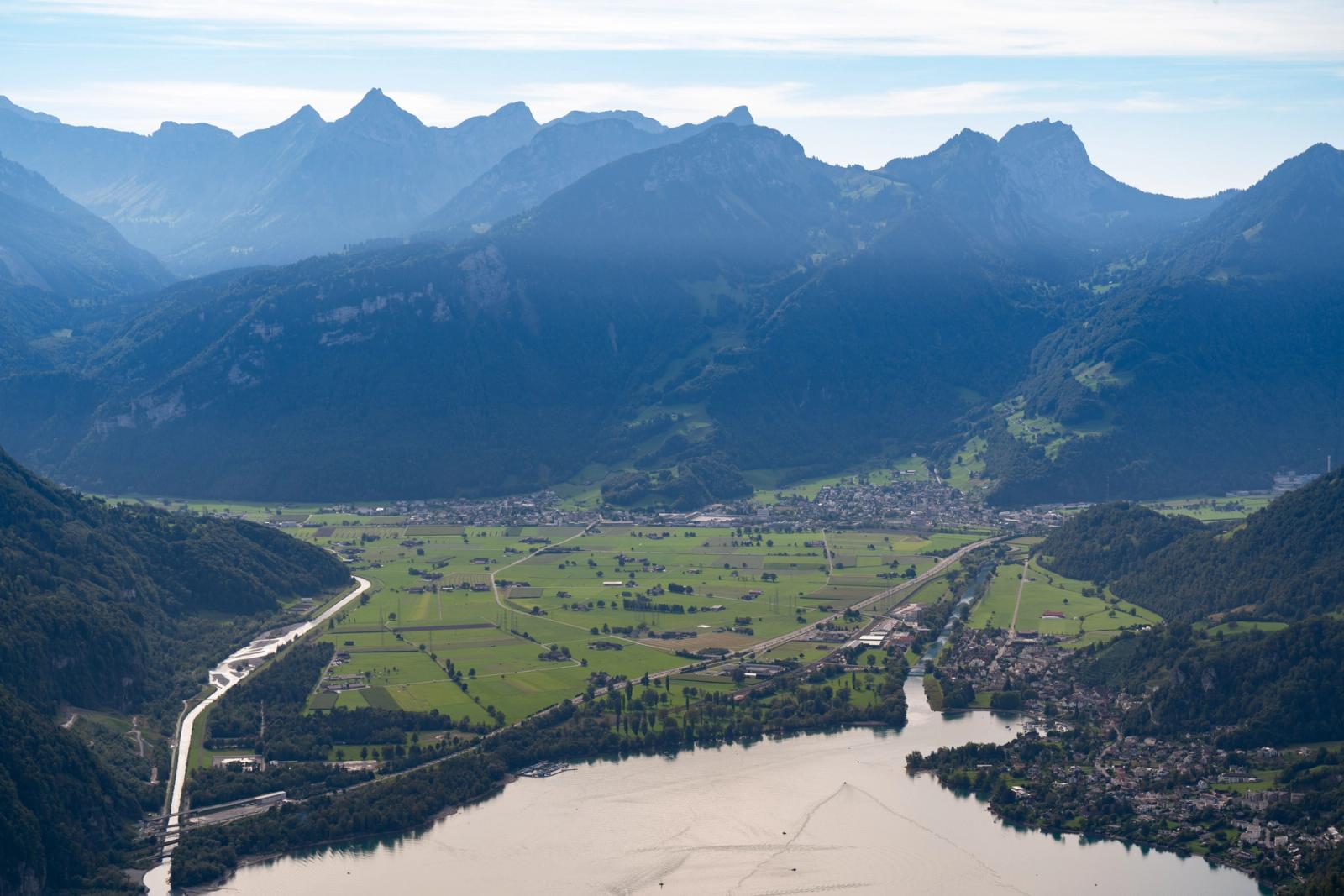 A breathtaking aerial view showcasing the Swiss Alps and lush valley, perfect for nature enthusiasts