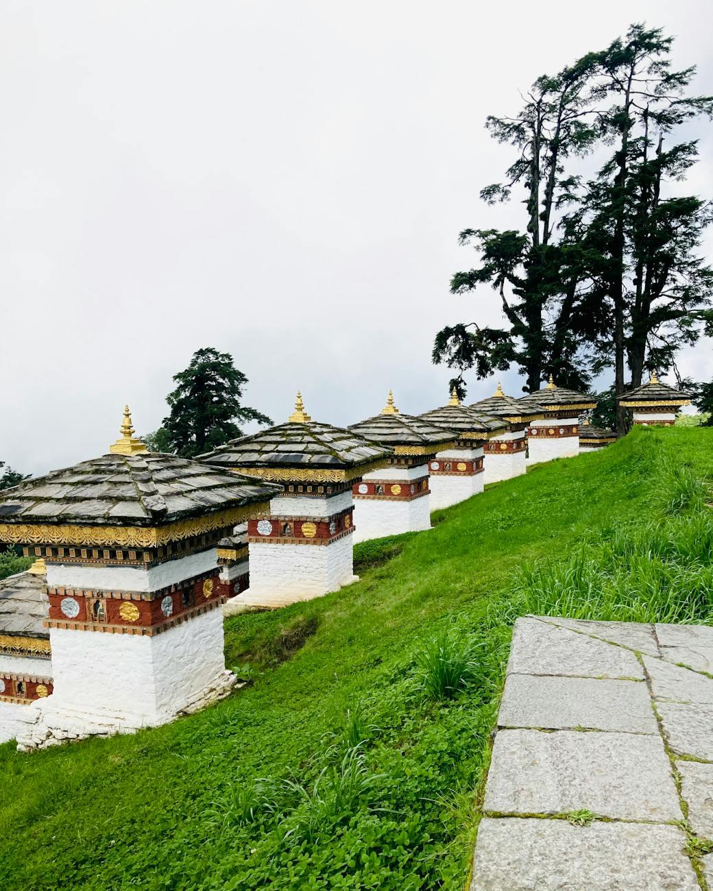 A peaceful view of the iconic stupas at Dochula Pass in Bhutan surrounded by lush greenery