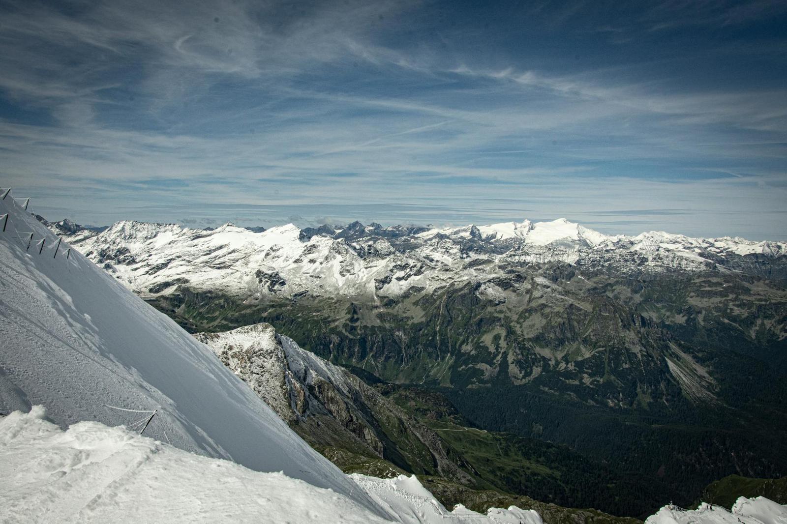 Snow-covered ridge overlooking a wide range of distant mountain peaks