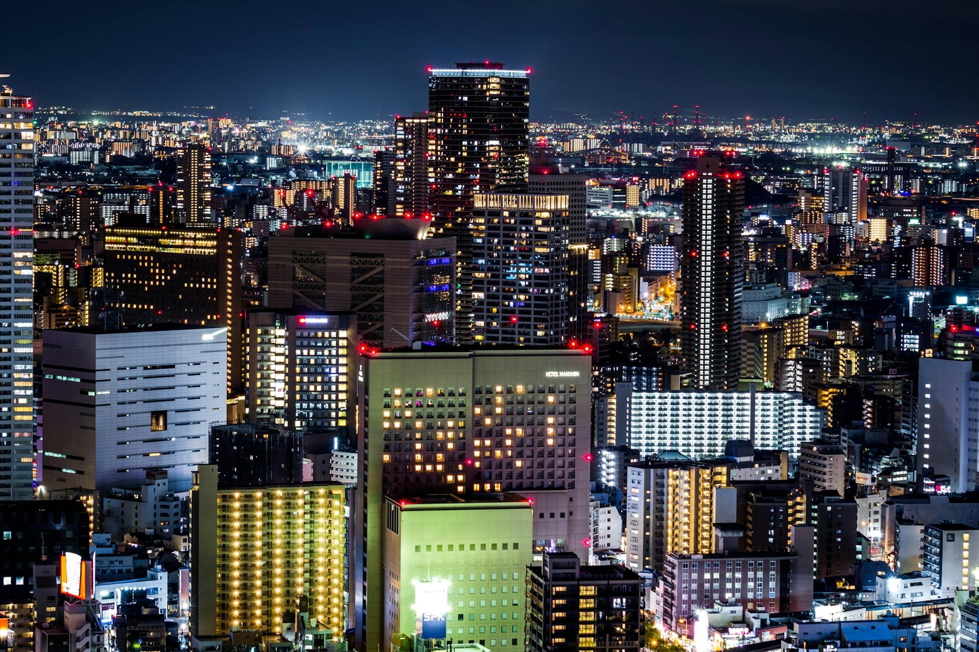 A densely lit city skyline glittering against the night sky