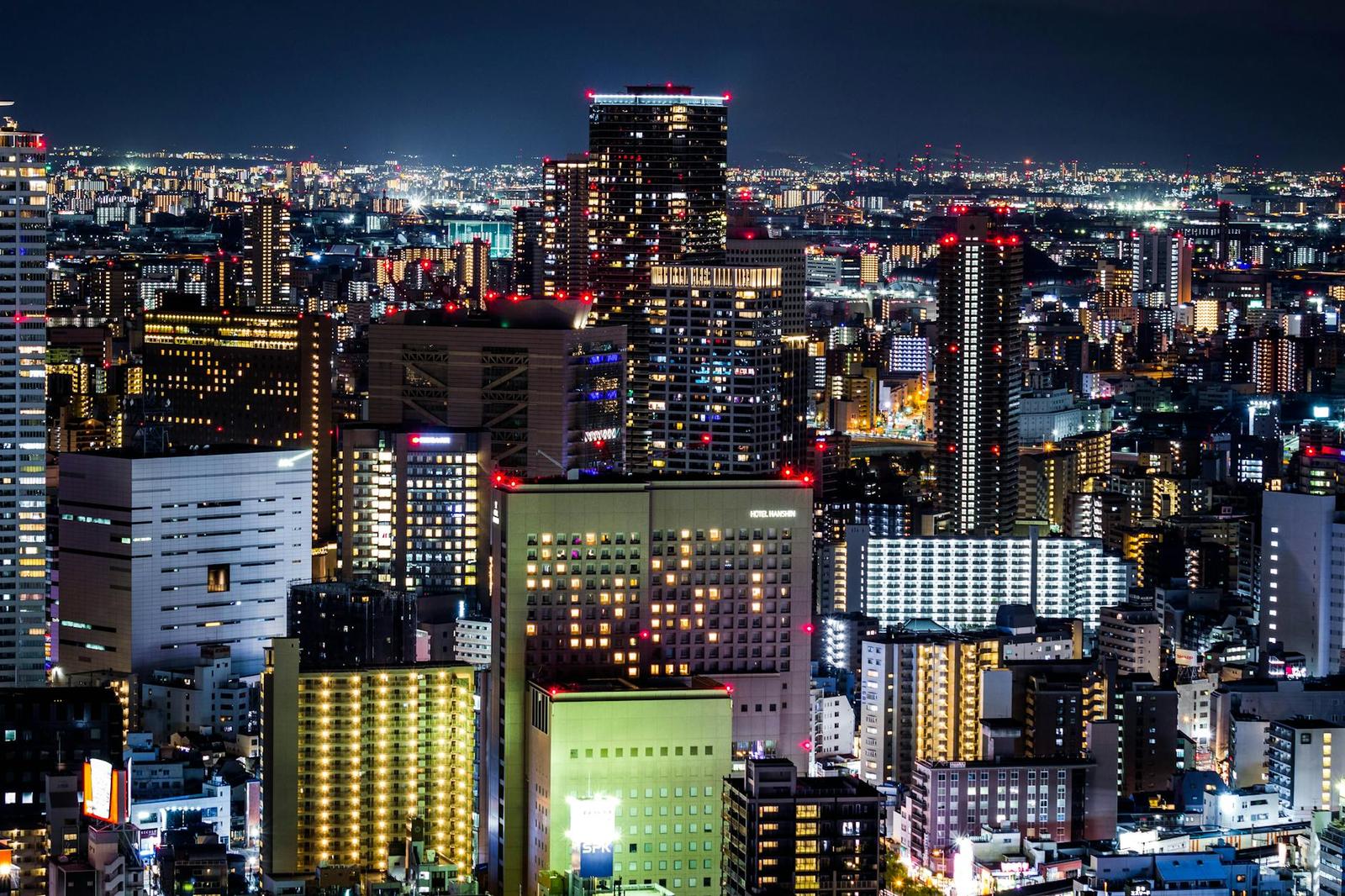 A densely lit city skyline glittering against the night sky