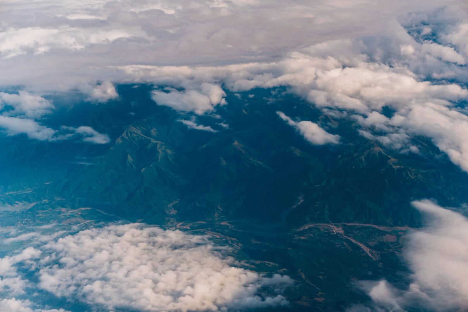 Aerial photograph capturing scenic mountains shrouded by clouds