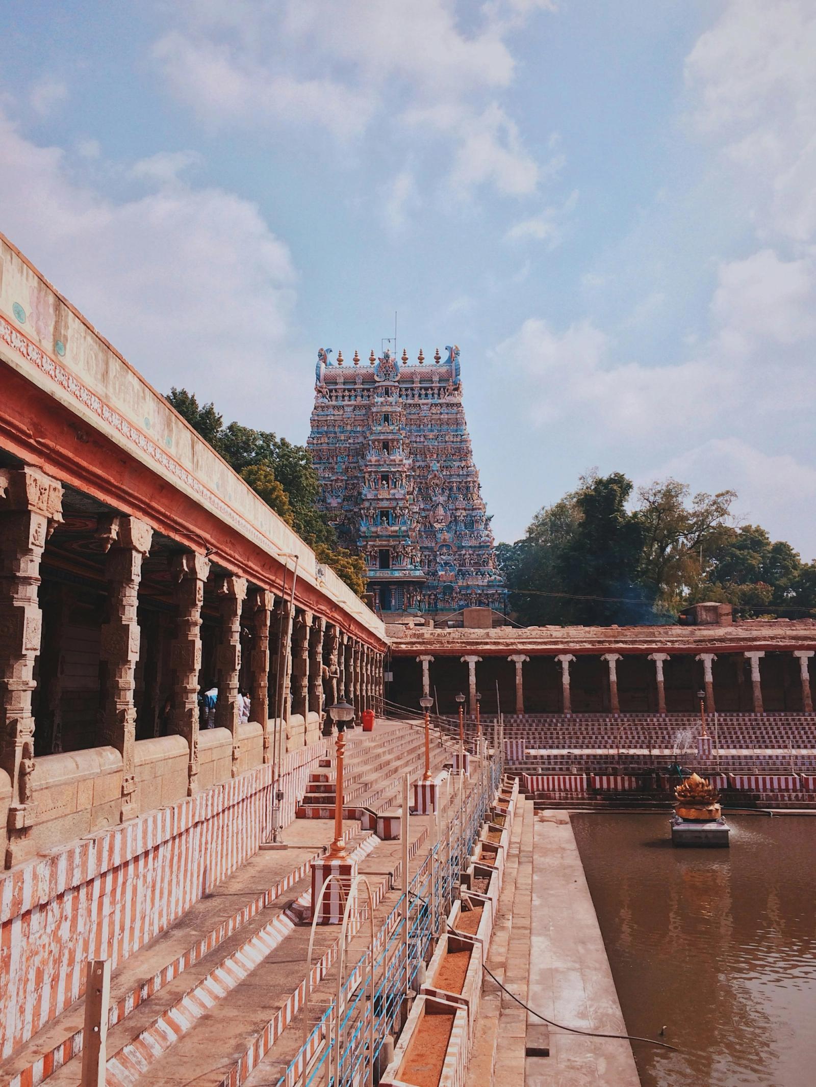 A towering carved temple gopuram against a bright sky.