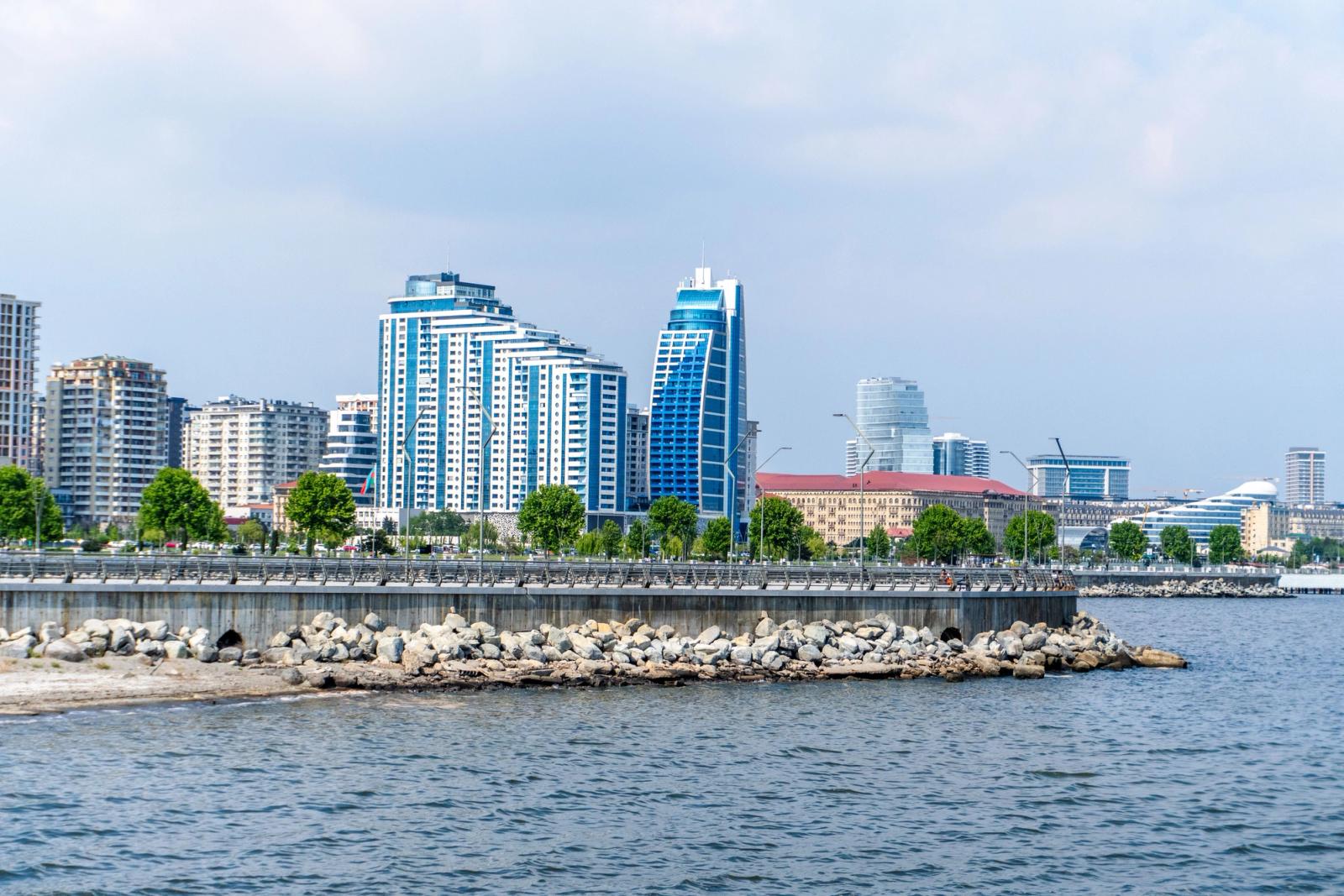 View of Baku's waterfront skyline featuring modern architecture and seaside promenade