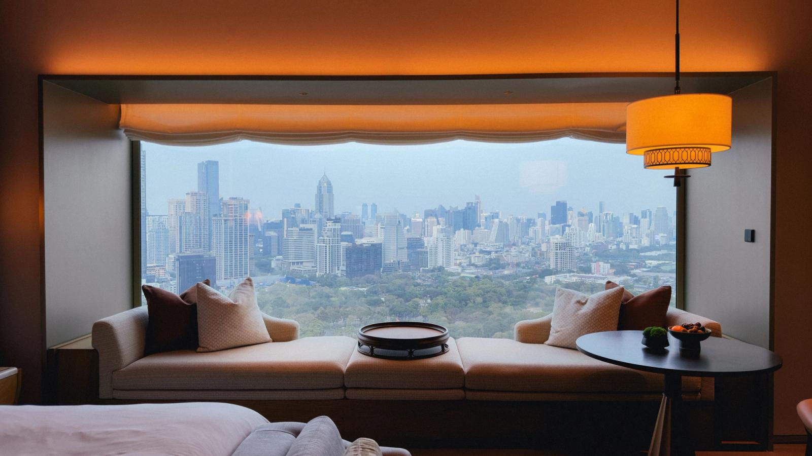 Elegant hotel room view overlooking the stunning Bangkok skyline during the day