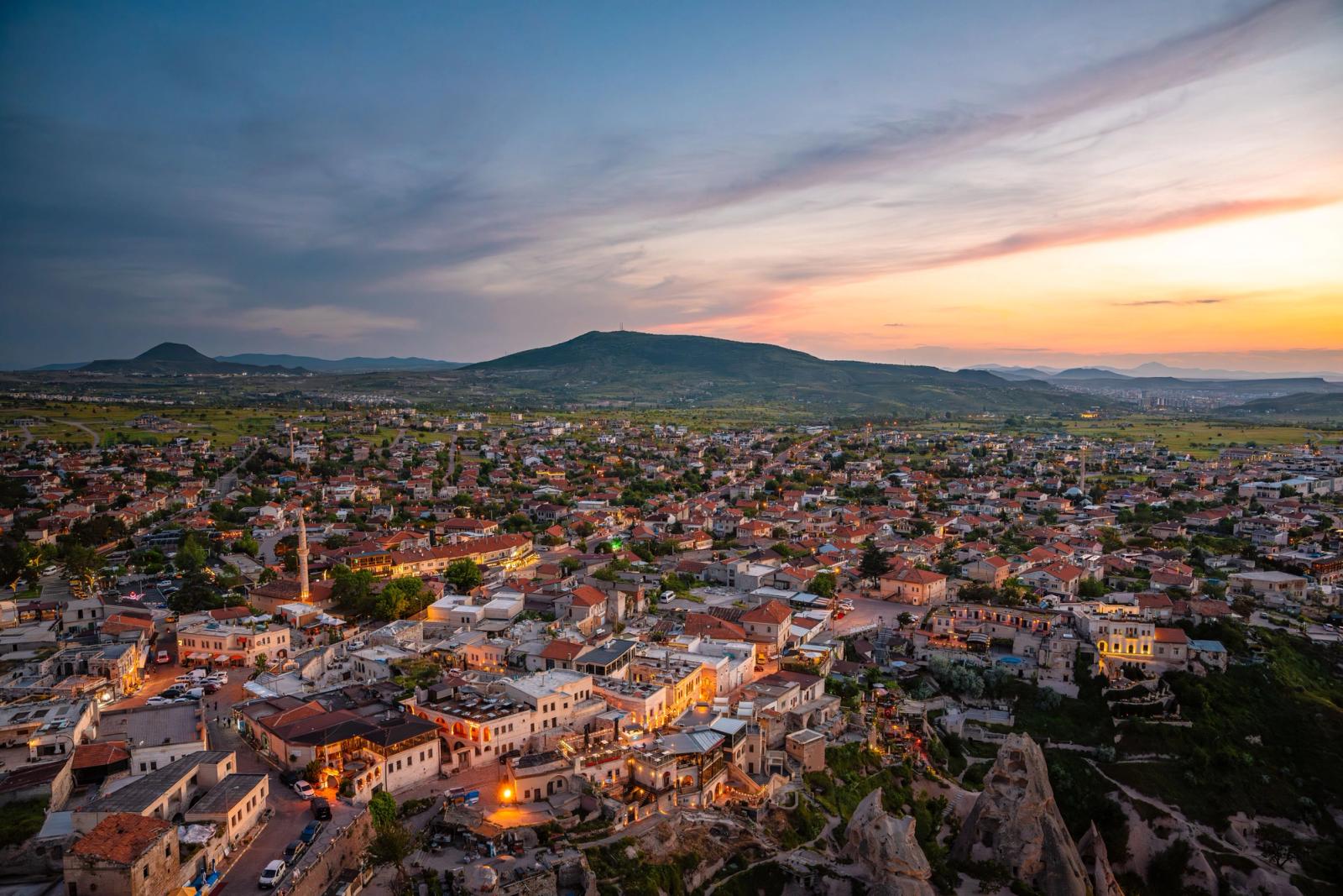 Stunning aerial view of Uchisar, Turkey with sunset hues illuminating the landscape