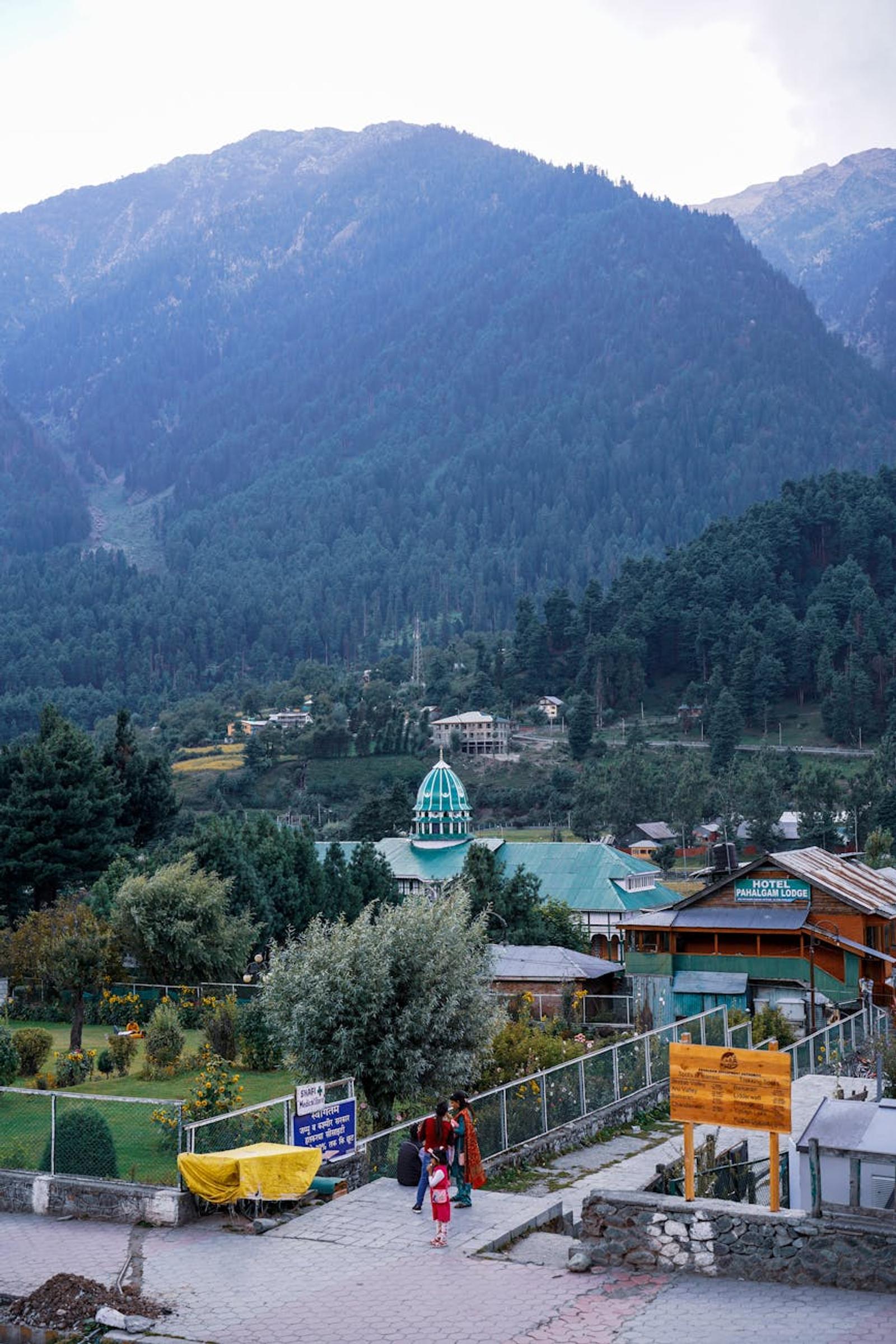 Majestic view of Pahalgam showcasing lush greenery, hills, and tranquil buildings