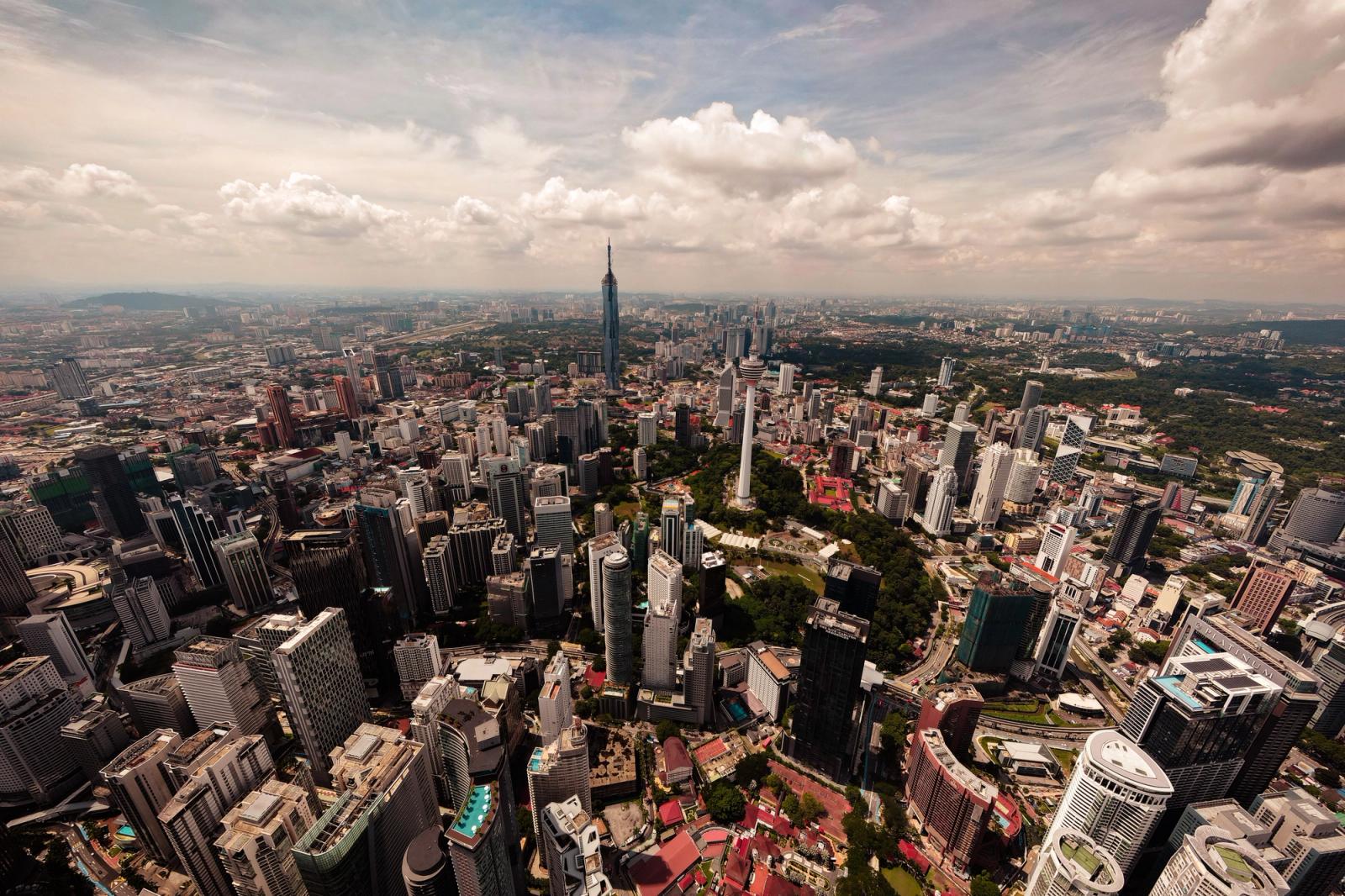 Stunning aerial view of Kuala Lumpur's cityscape featuring iconic skyscrapers and lush greenery