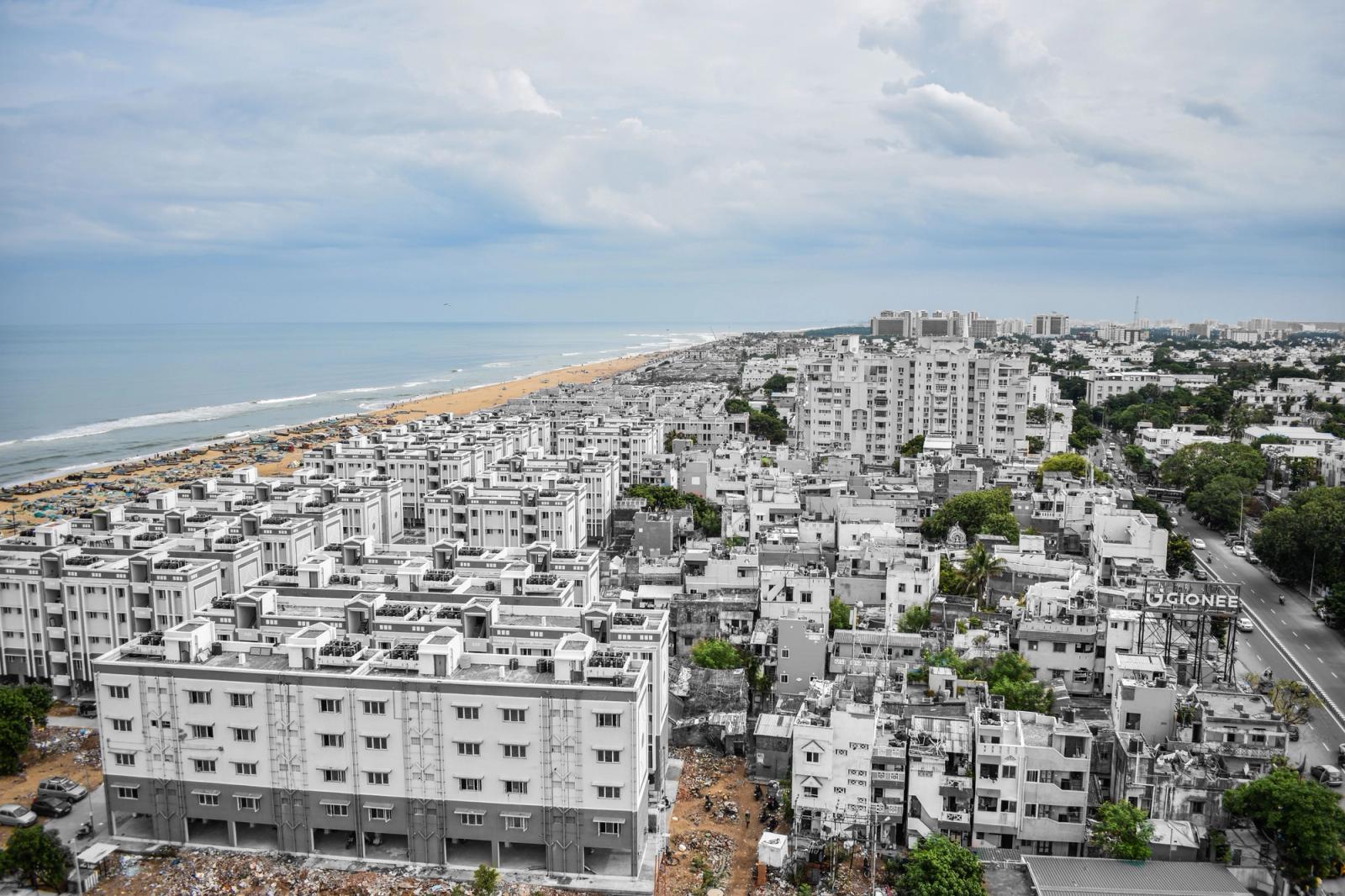 Aerial view of Chennai's urban landscape with Marina Beach in the background