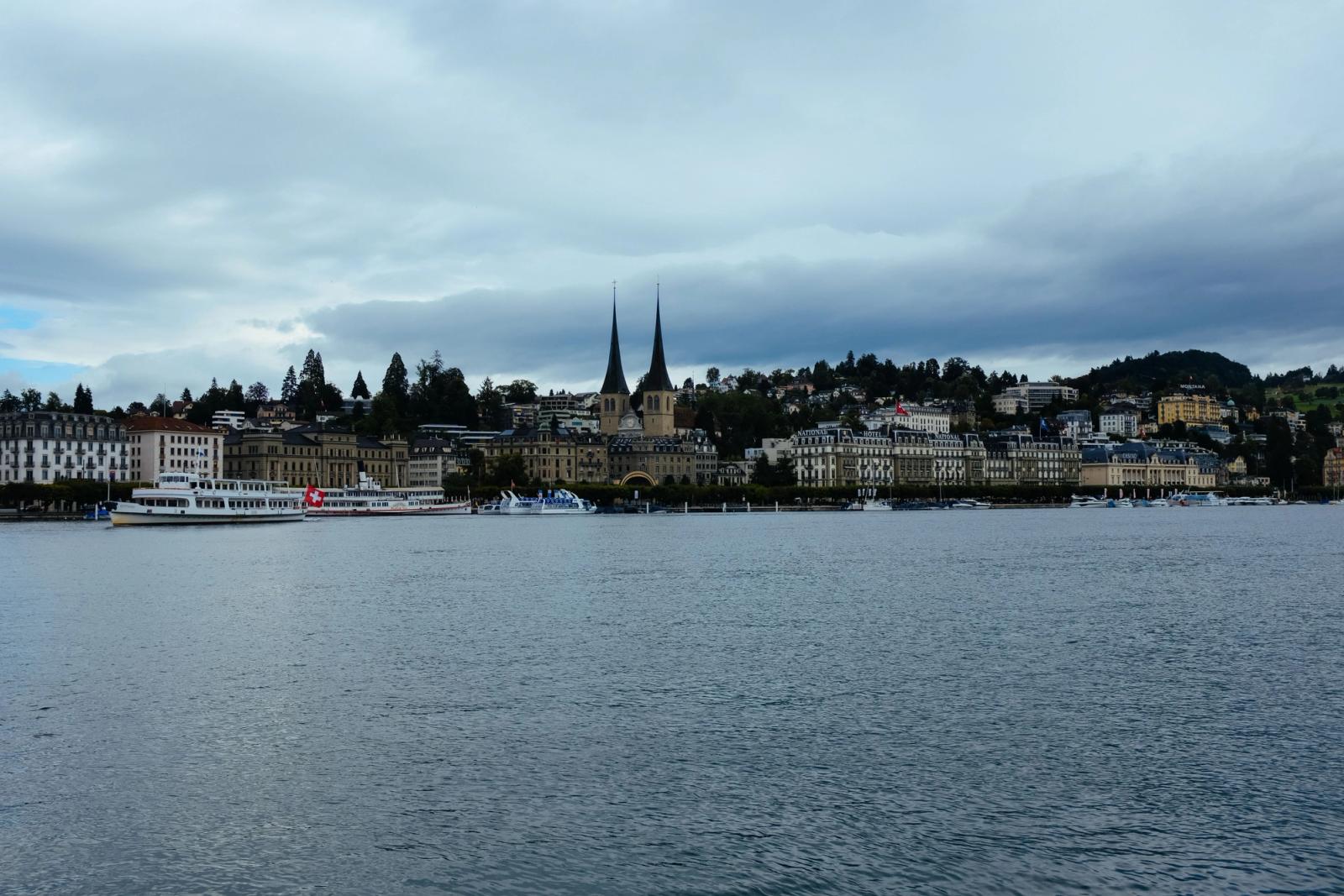 Picturesque waterfront view of Lucerne with iconic twin towers and overcast weather