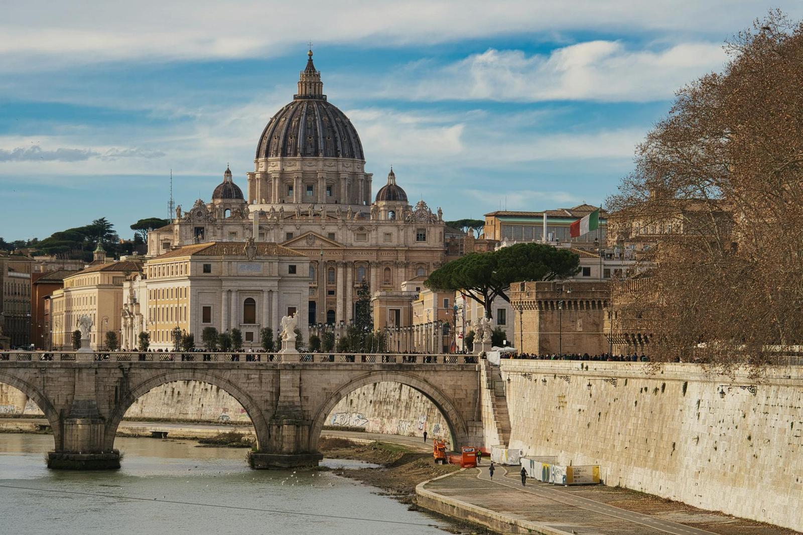 Scenic view of St. Peter's Basilica and bridge over the Tiber River in Rome