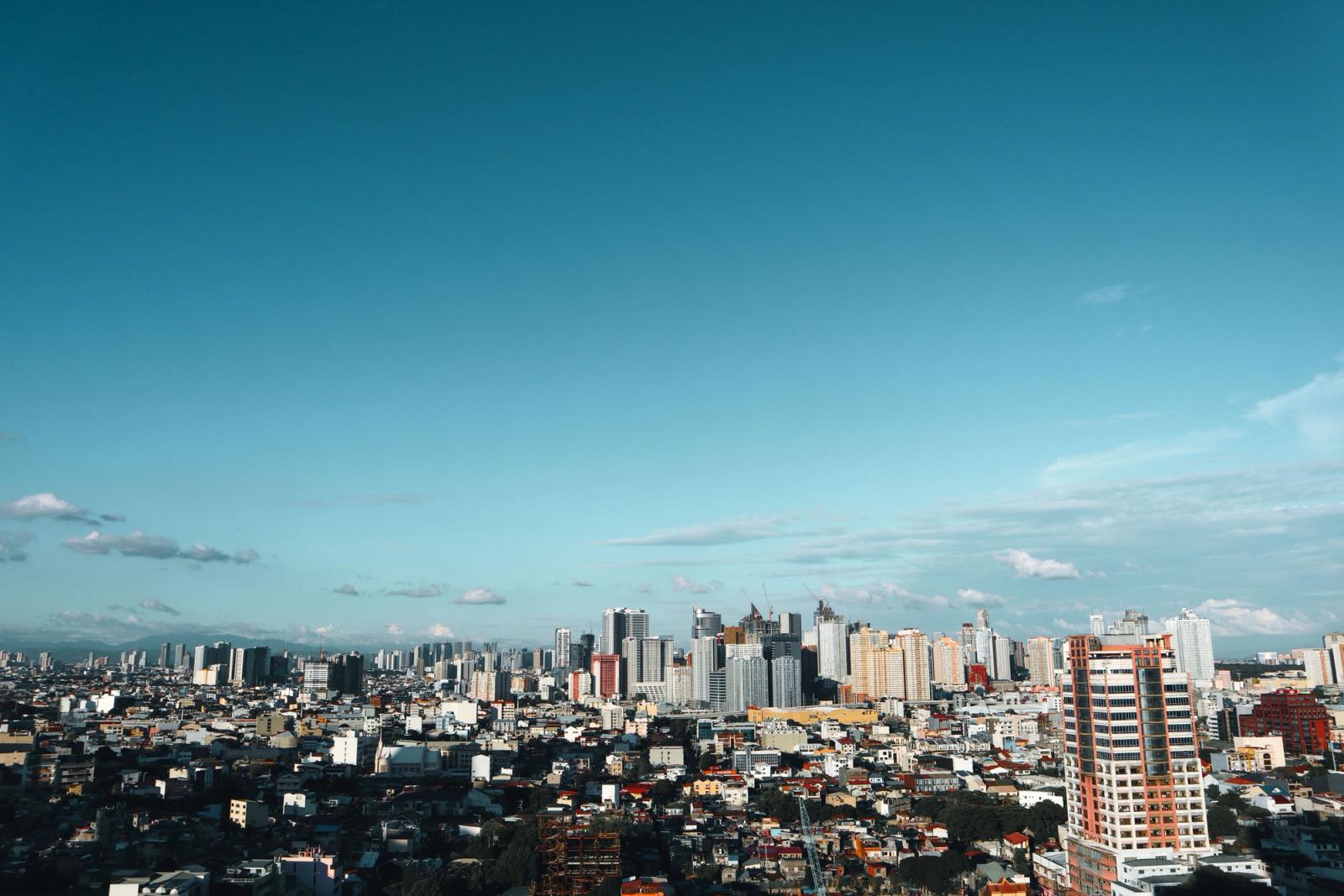Stunning view of the Manila cityscape with modern skyscrapers under a clear blue sky