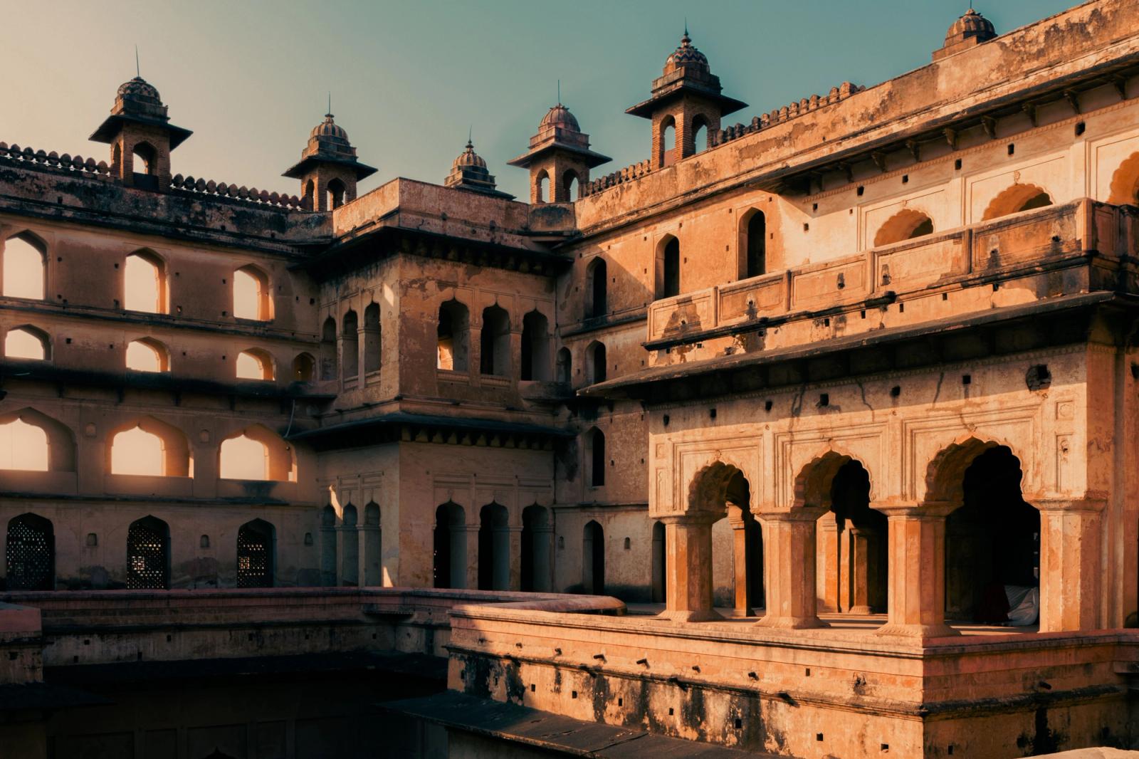 Capture of the iconic Raja Mahal showcasing Rajput architecture in Orchha, India at sunset