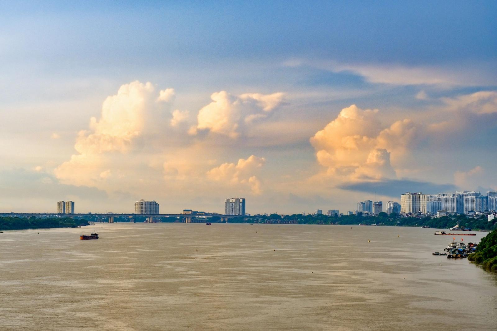 Beautiful view of Long Biên Bridge over the Red River in Hanoi, Vietnam with cityscape and cloudscape