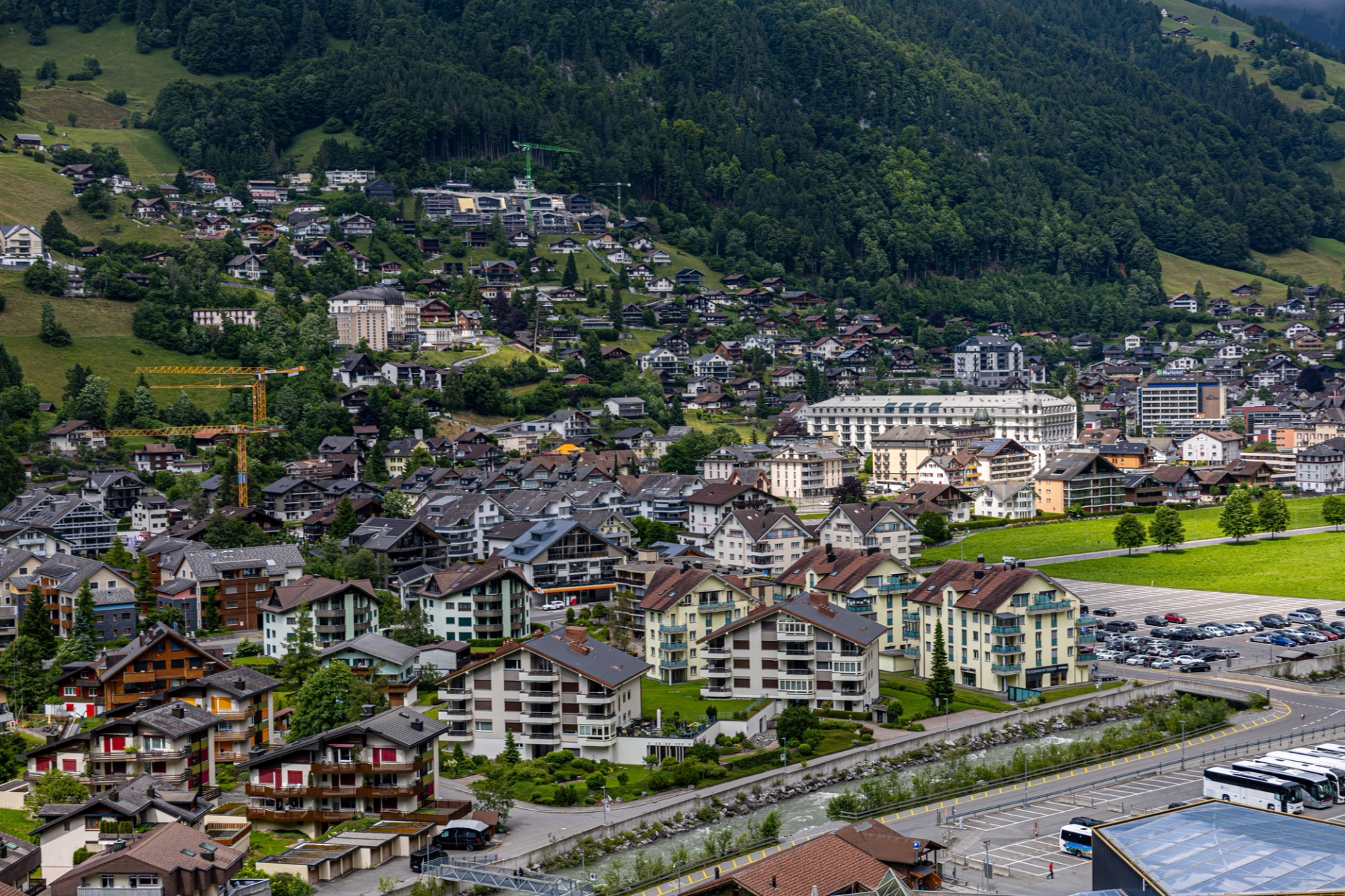 A beautiful aerial view of Engelberg, Switzerland showcasing charming houses and lush mountains