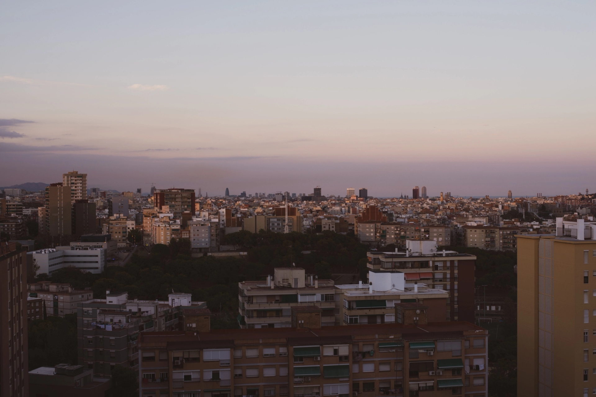 A stunning overview of Barcelona's architecture as twilight sets in, showcasing urban density and skyline