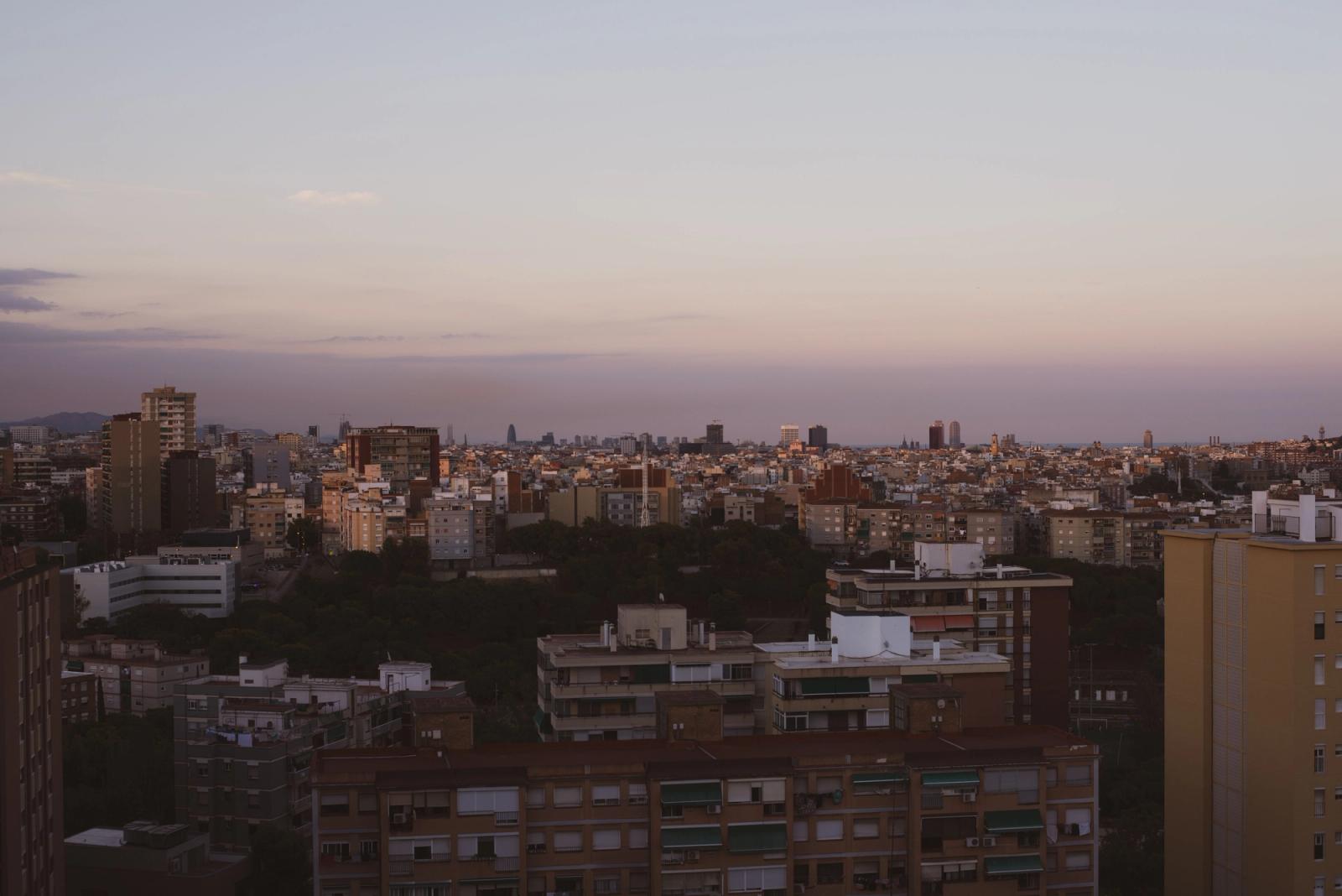 A stunning overview of Barcelona's architecture as twilight sets in, showcasing urban density and skyline