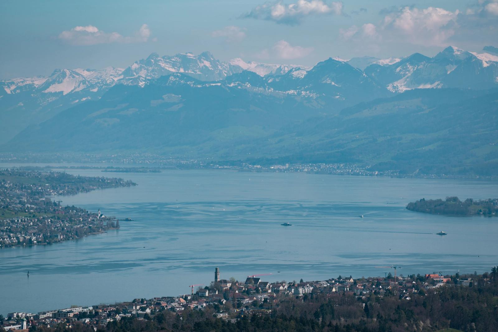 Scenic aerial view of Lake Zurich surrounded by the Swiss Alps, showcasing beautiful mountain landscapes and serene waters