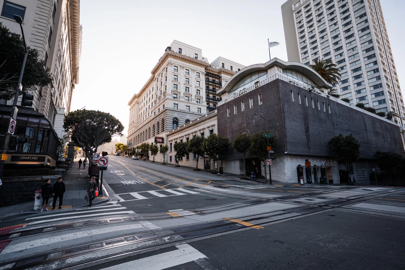 Street view of San Francisco with historic buildings and modern skyscrapers at dusk