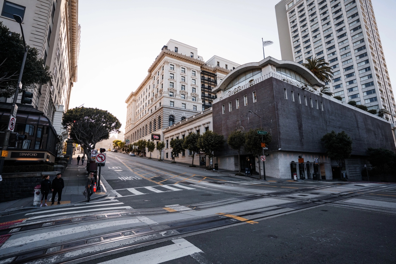 Street view of San Francisco with historic buildings and modern skyscrapers at dusk