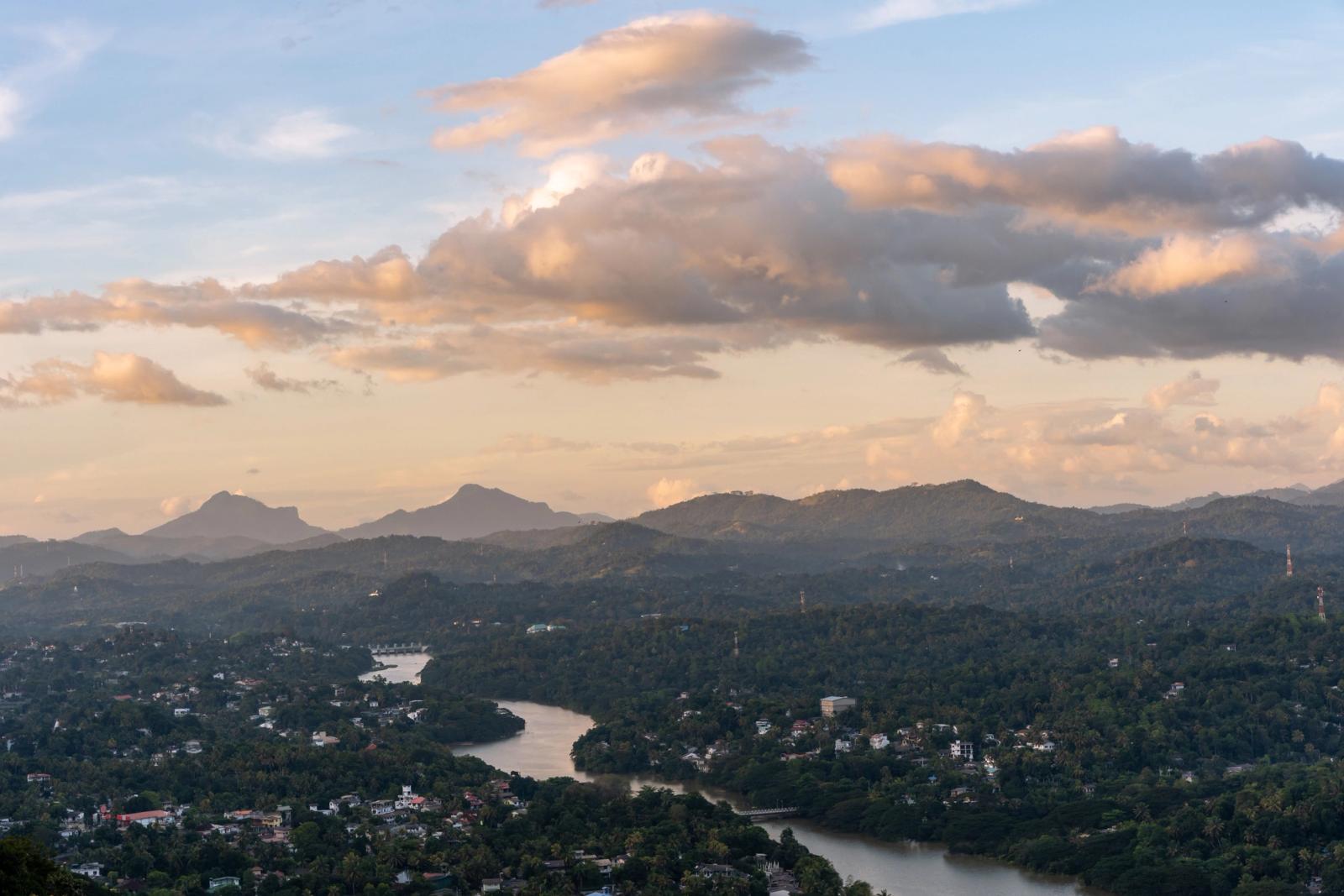 Beautiful landscape with river, hills, and a dramatic sky at dusk in Sri Lanka