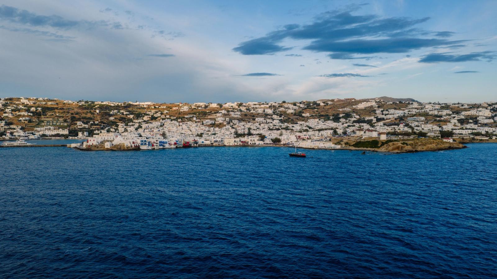 Aerial view of Mykonos Island's white architecture against the blue sea in Greece