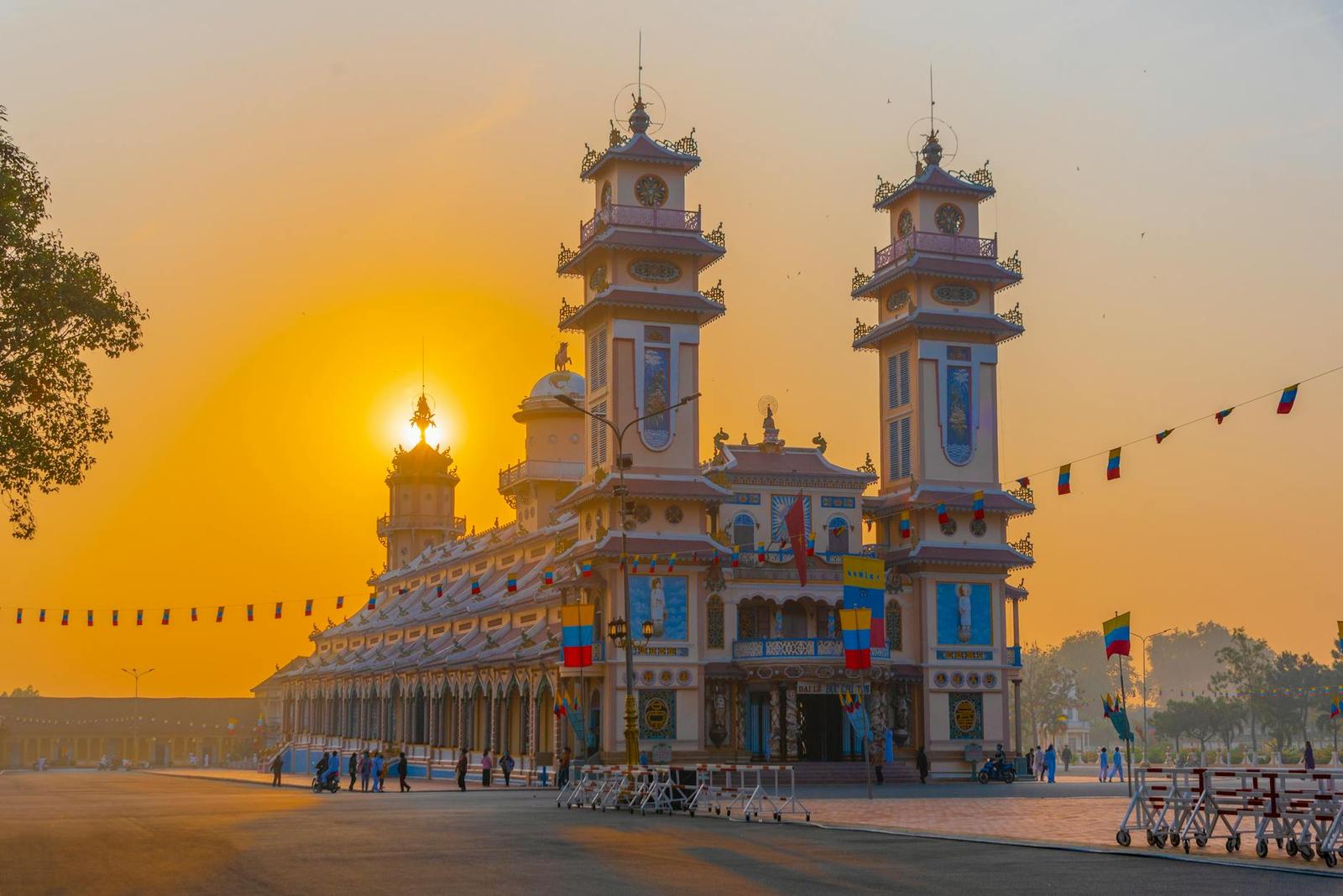 Ornate twin-towered temple glowing gold in the haze of a low sun