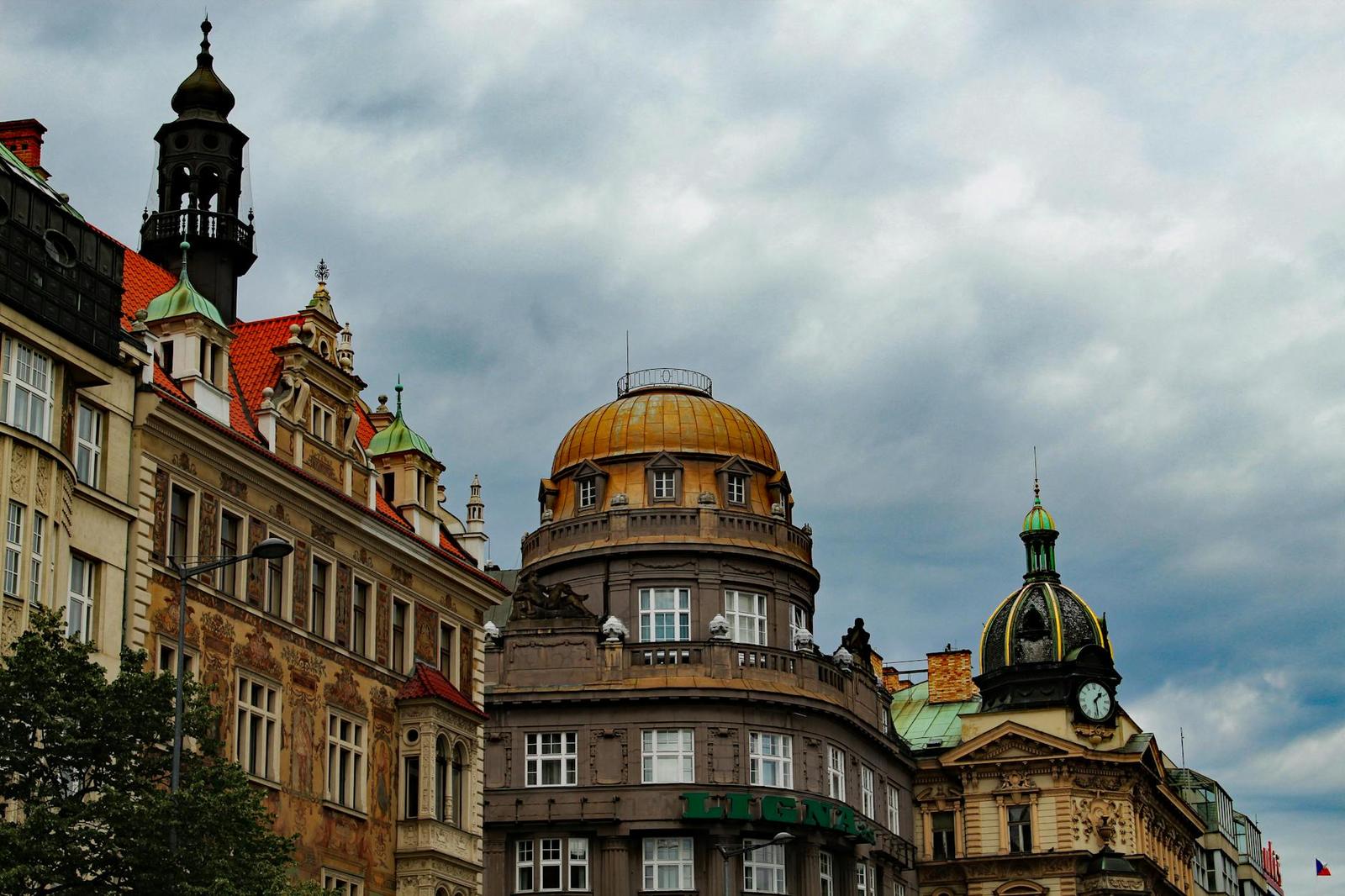 Dramatic view of historical buildings under a cloudy Prague sky in the city center