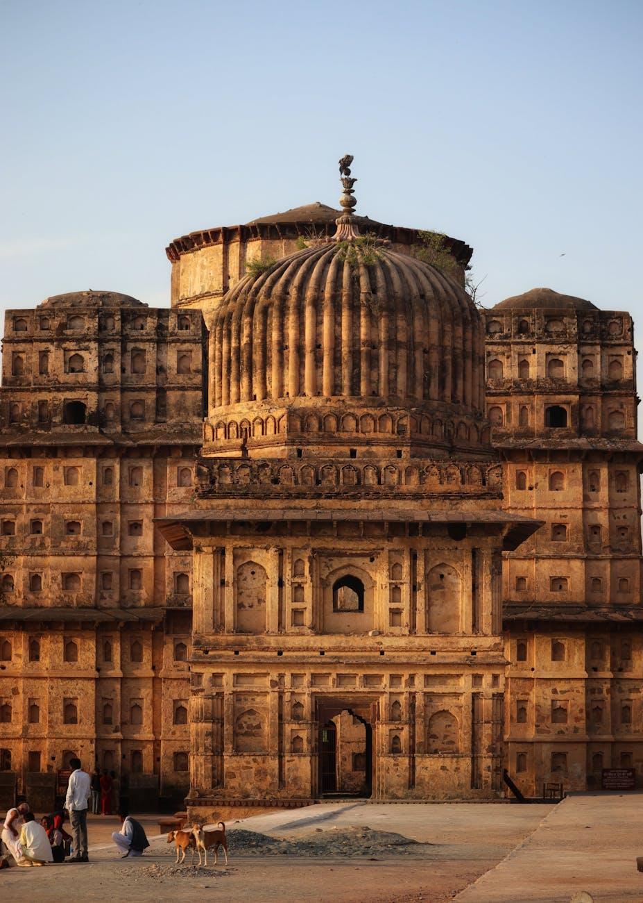 Iconic Chhatris in Orchha, India with golden hues at sunset, featuring historical architectural splendor