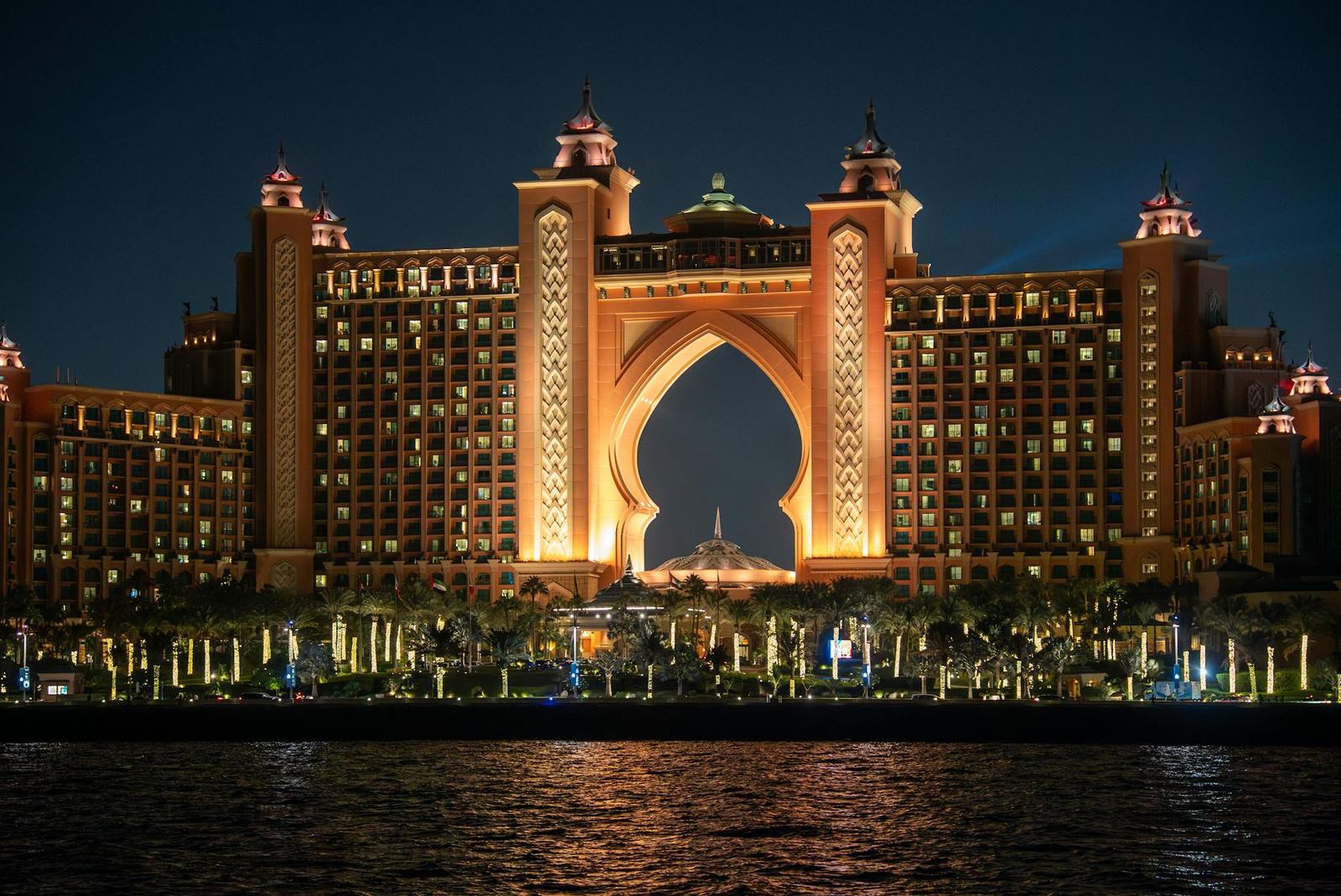 Stunning night view of Atlantis The Palm hotel in Dubai, UAE, glowing with warm lights