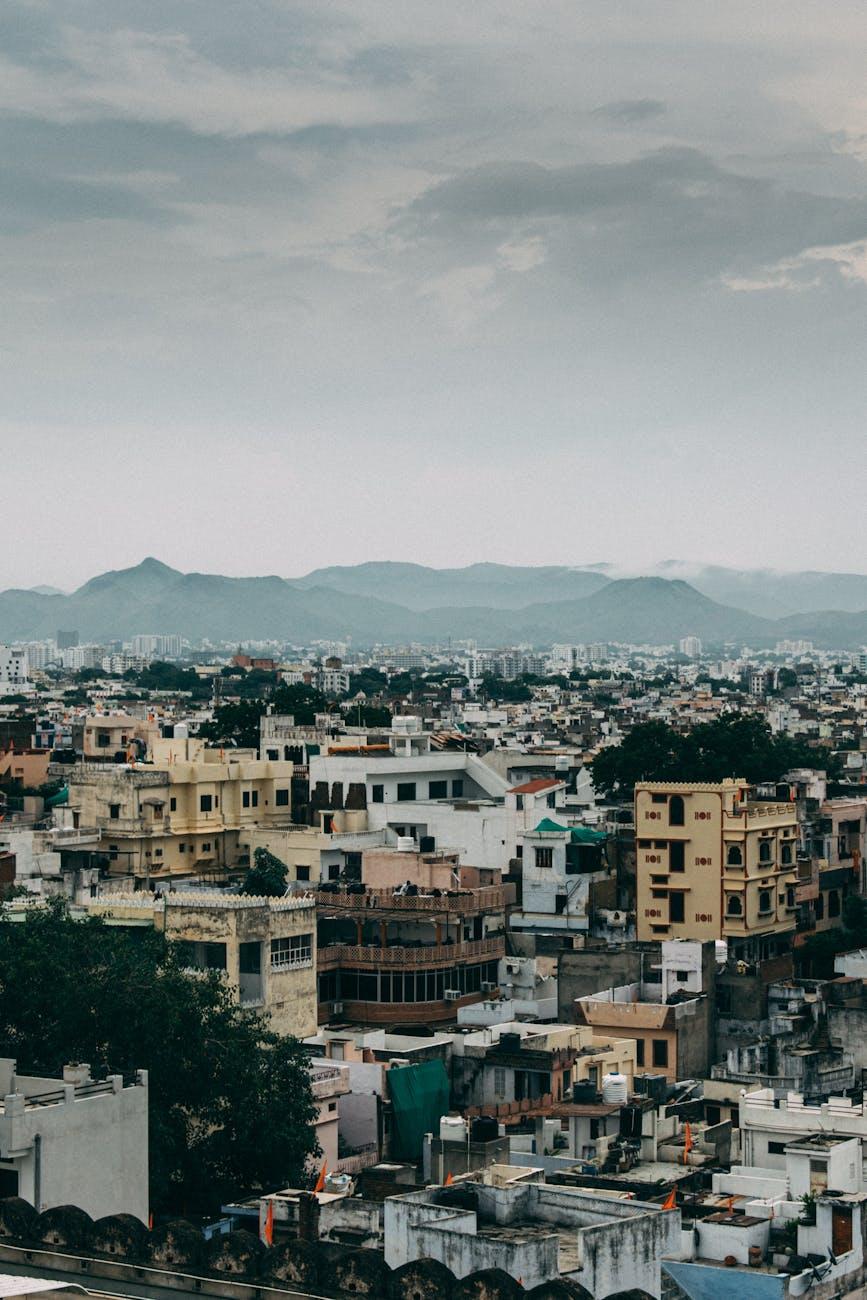 Discover the vibrant urban landscape of Udaipur, India, against a majestic mountainous backdrop