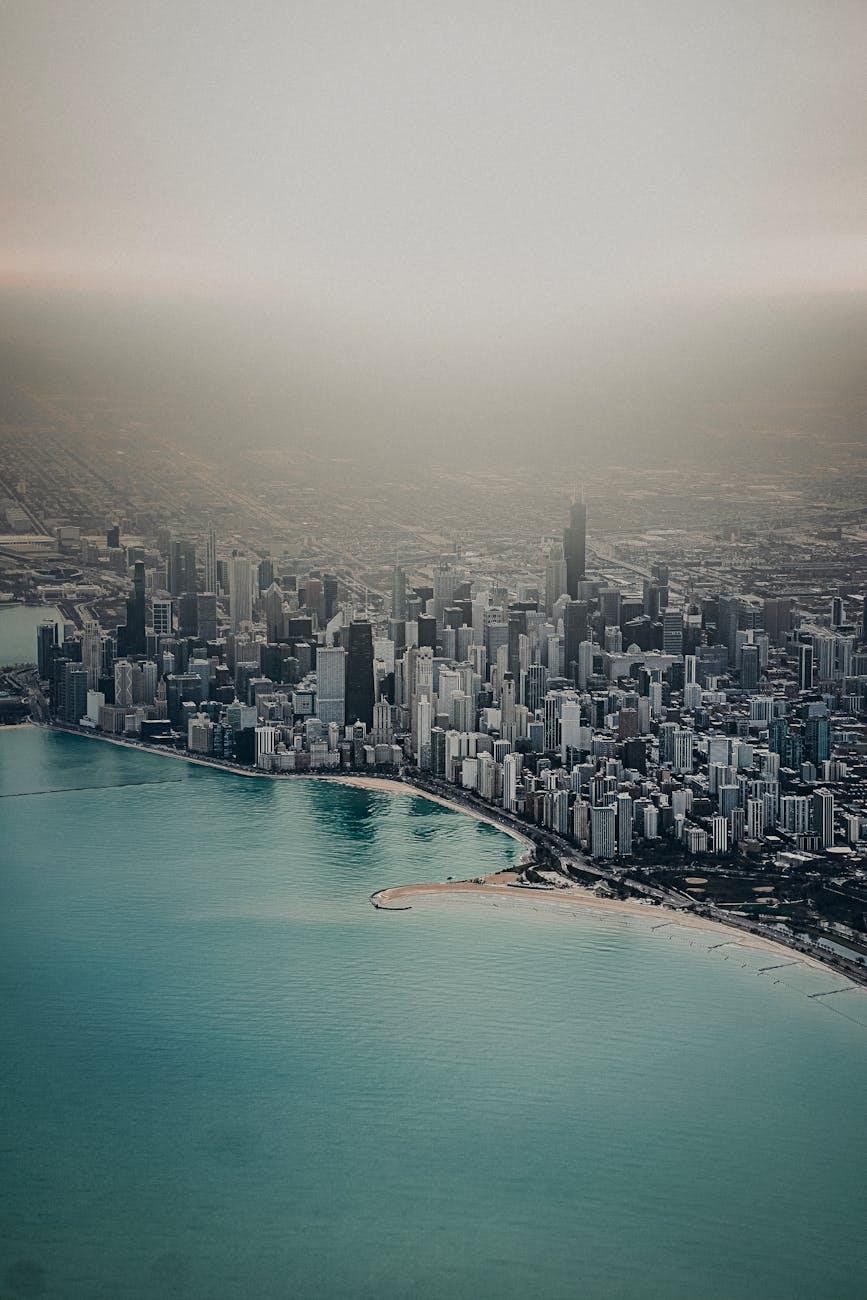 Aerial view of a lakefront skyline wrapped in haze