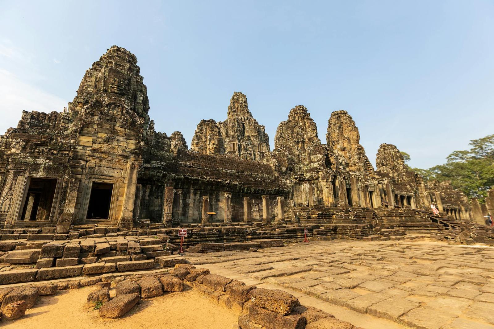 Stone towers carved with giant faces rising over the ruins of Angkor's Bayon temple