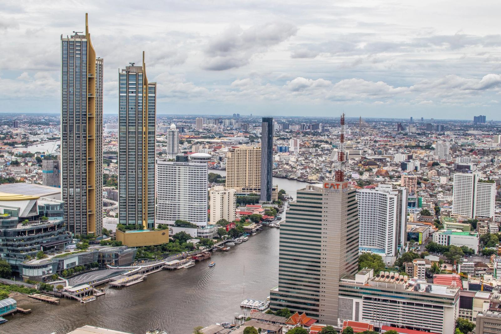 Stunning aerial view of Bangkok showcasing modern skyscrapers along the Chao Phraya River