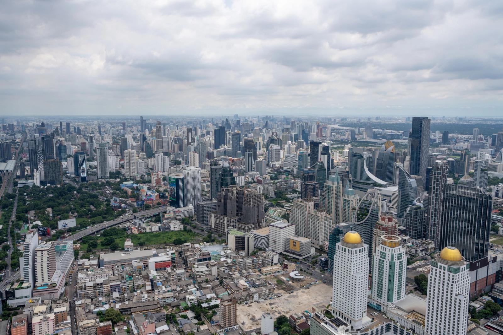 Stunning aerial view of Bangkok's modern skyline under clouded skies