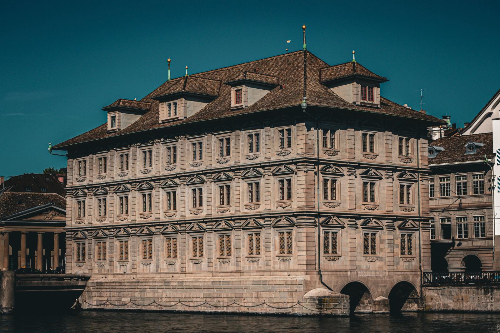 Explore the elegant Renaissance architecture of Zurich's iconic town hall by the river