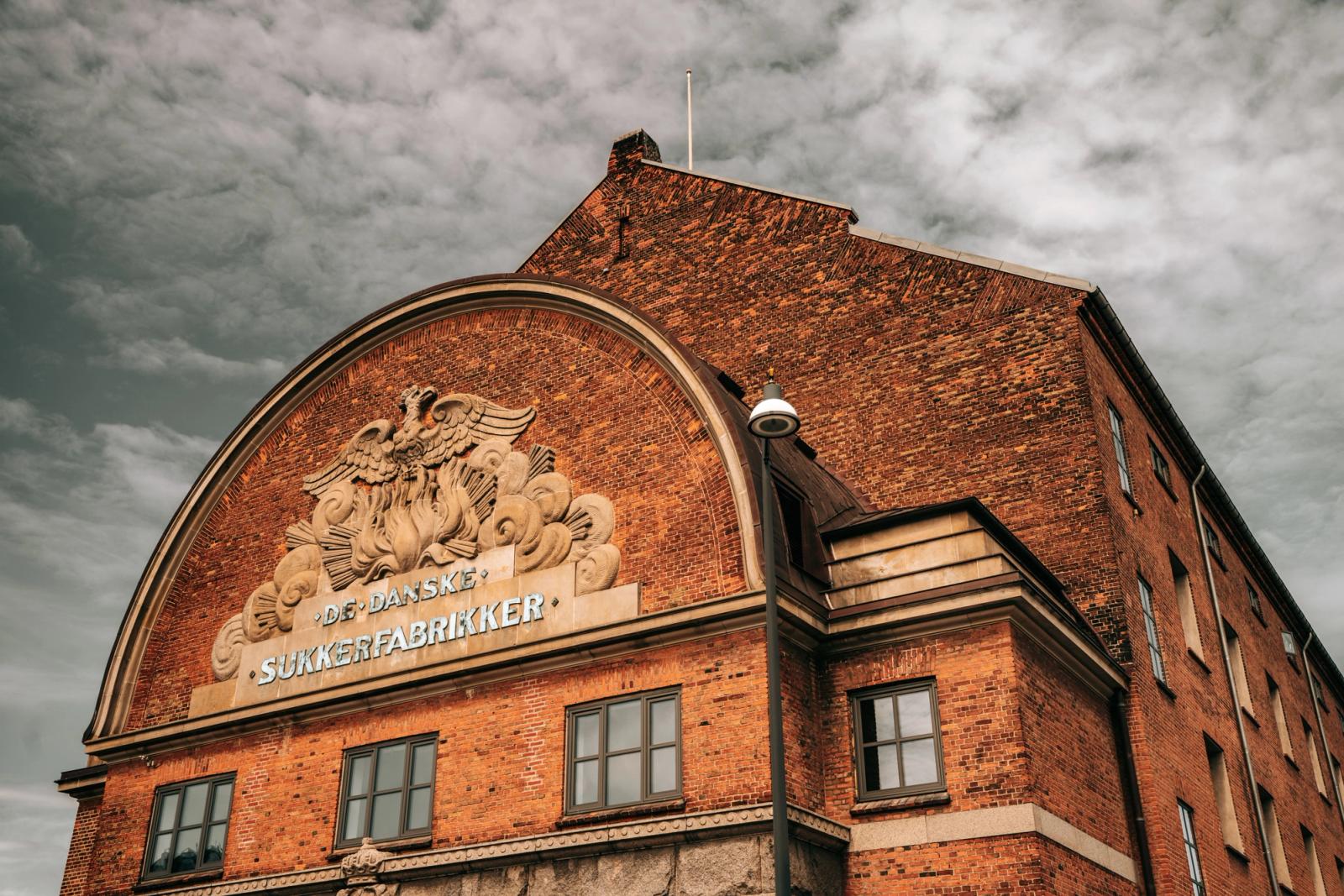 A picturesque view of the historic De Danske Sukkerfabrikker building in Copenhagen, Denmark