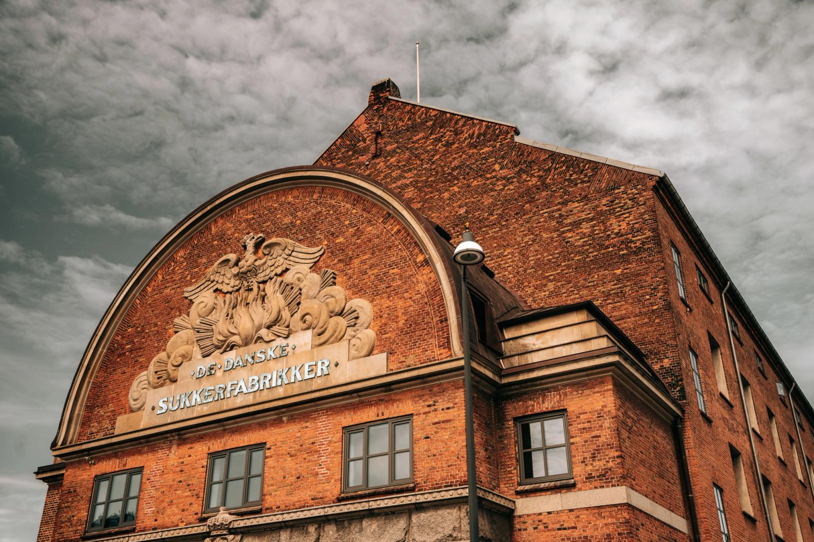 A picturesque view of the historic De Danske Sukkerfabrikker building in Copenhagen, Denmark