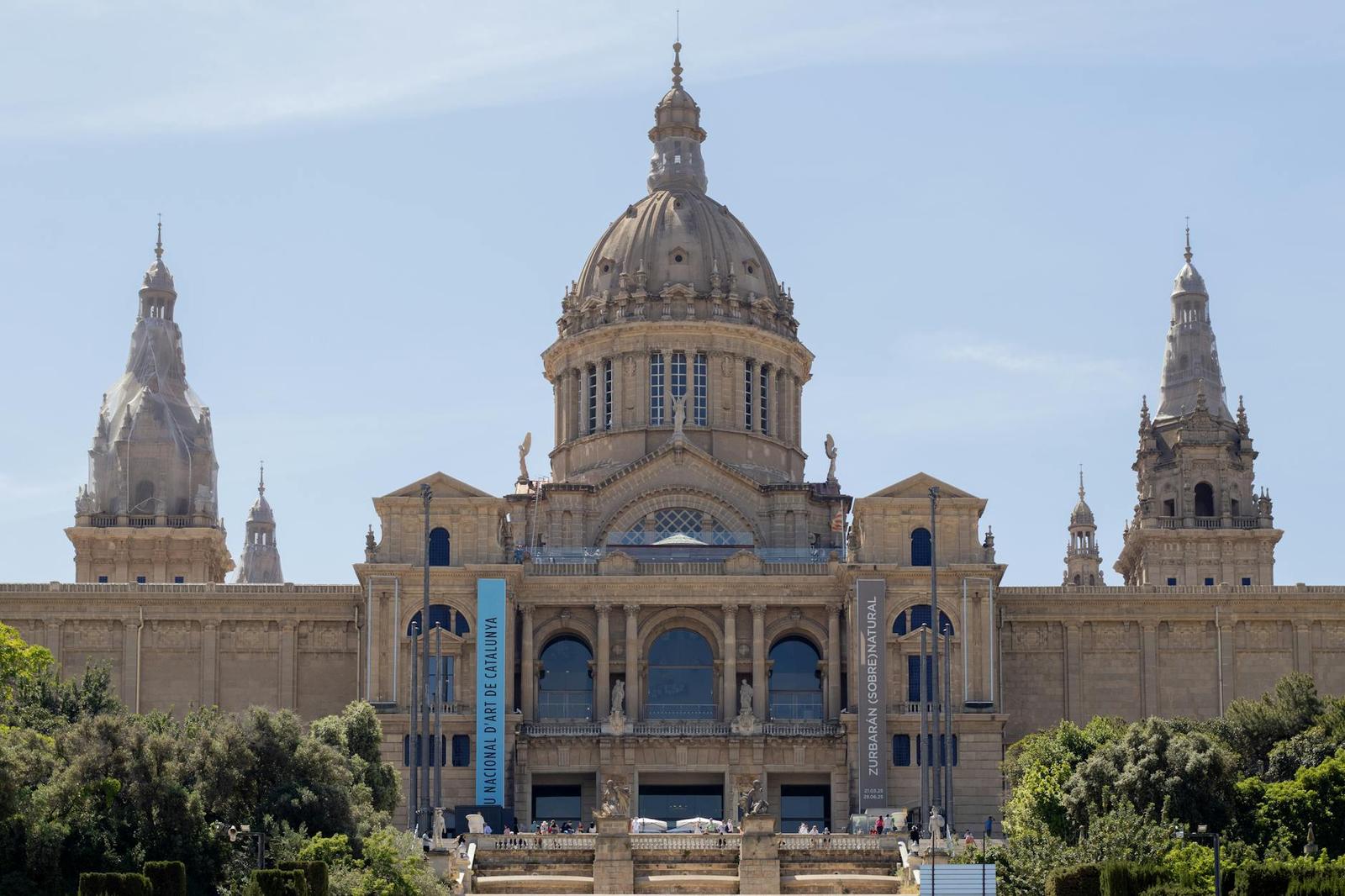 Front view of the National Art Museum of Catalonia showcasing its grand architecture under a clear sky