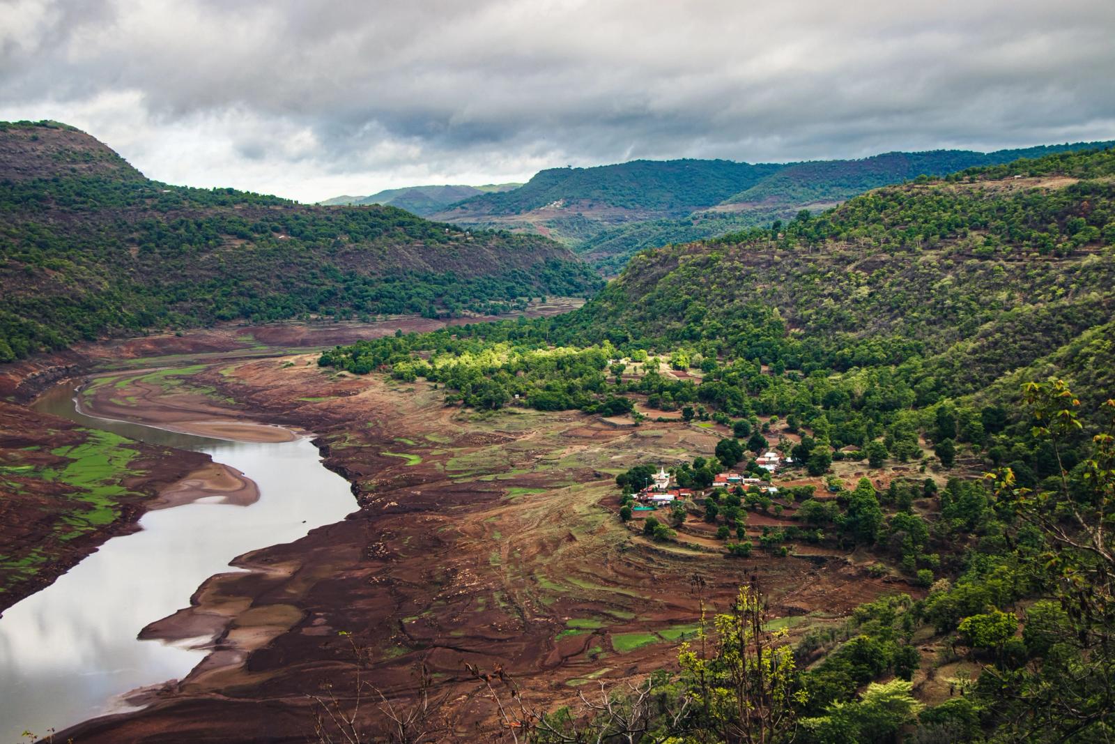 Aerial view of lush green mountains and river in Bhimashankar, India