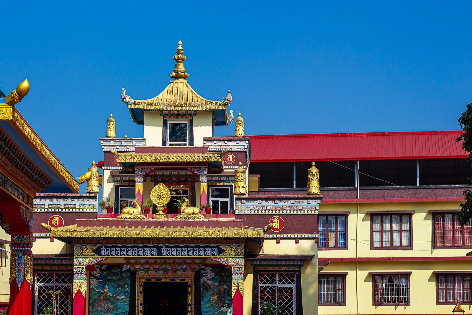 Vibrant Tibetan monastery with intricate details and blue sky backdrop. Perfect for travel and cultural themes