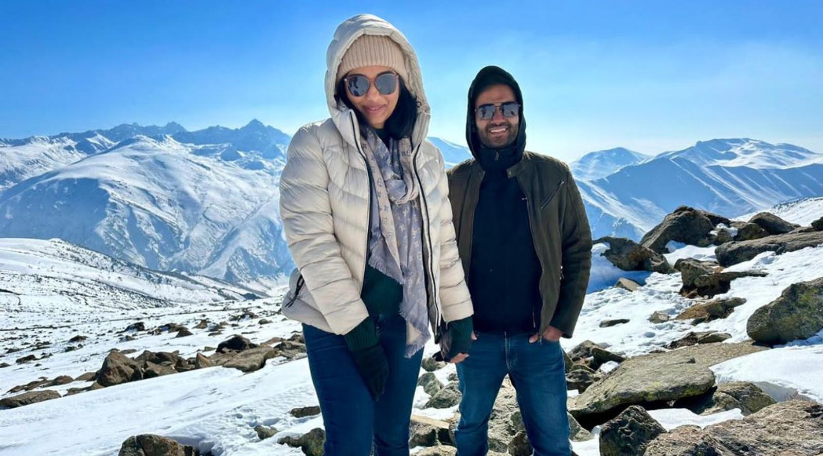 Two people posing on a rocky