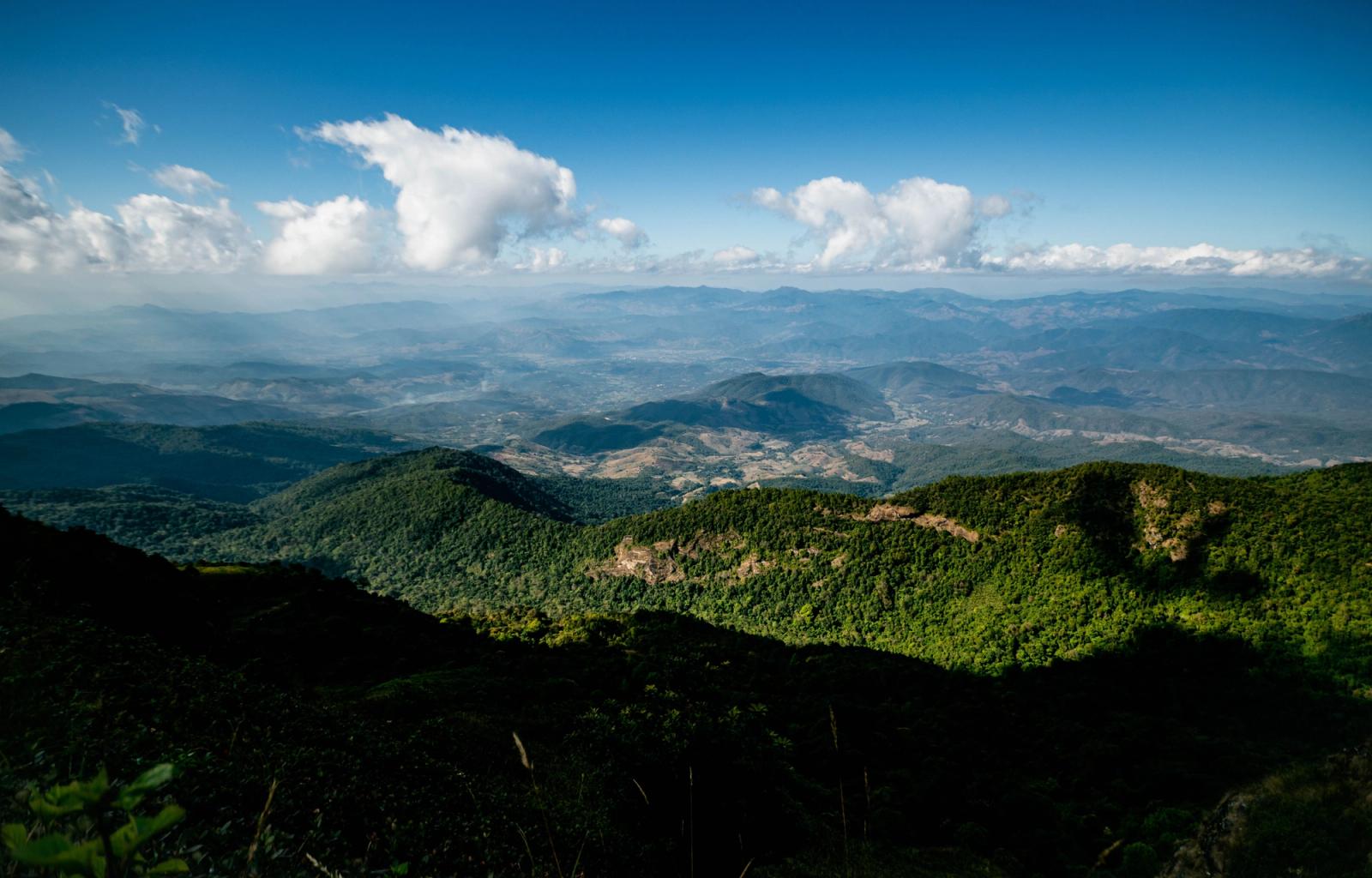 Expansive view of lush green mountains and clouds in Chiang Mai, Thailand